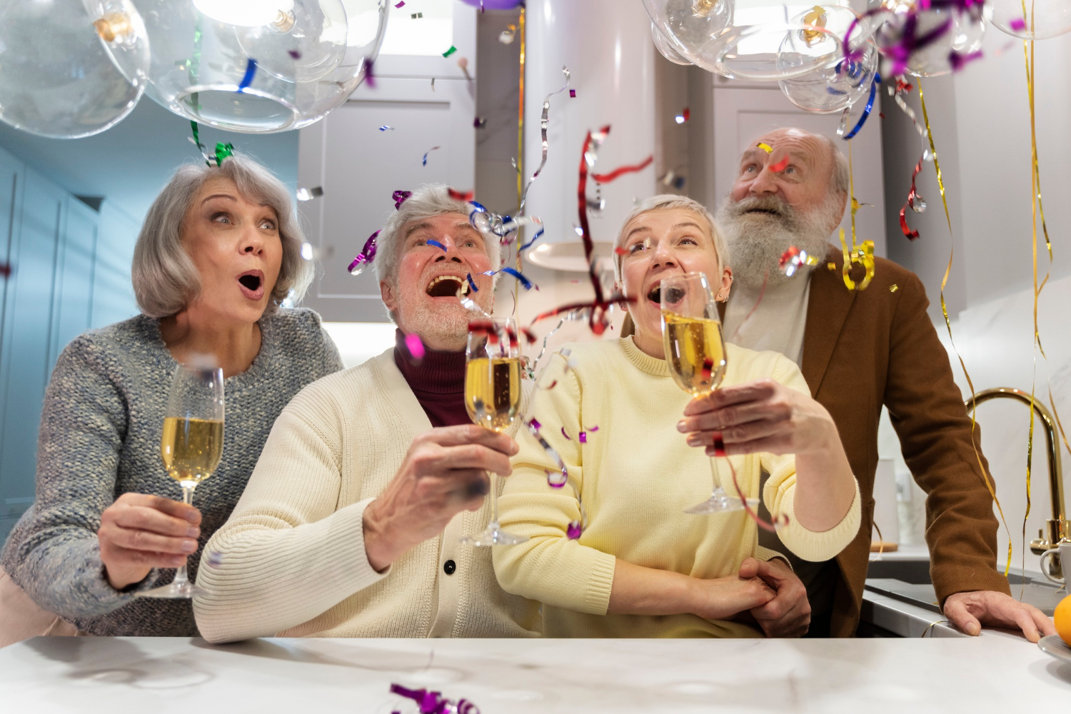 A group of people holding champagne flutes and laughing | Source: Freepik