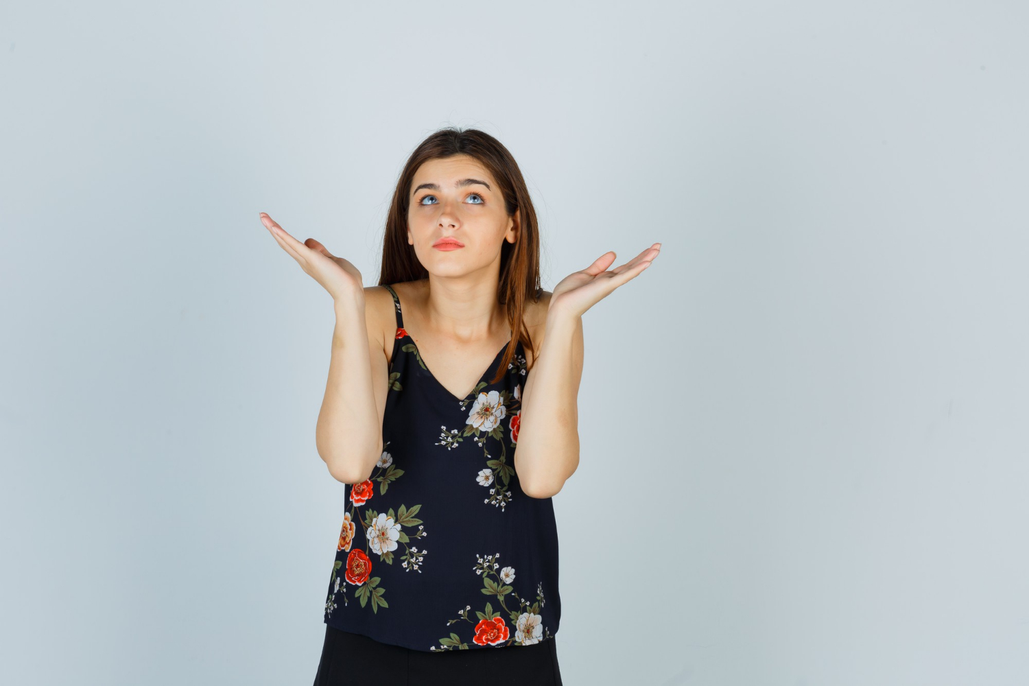 A woman shrugging | Source: Freepik