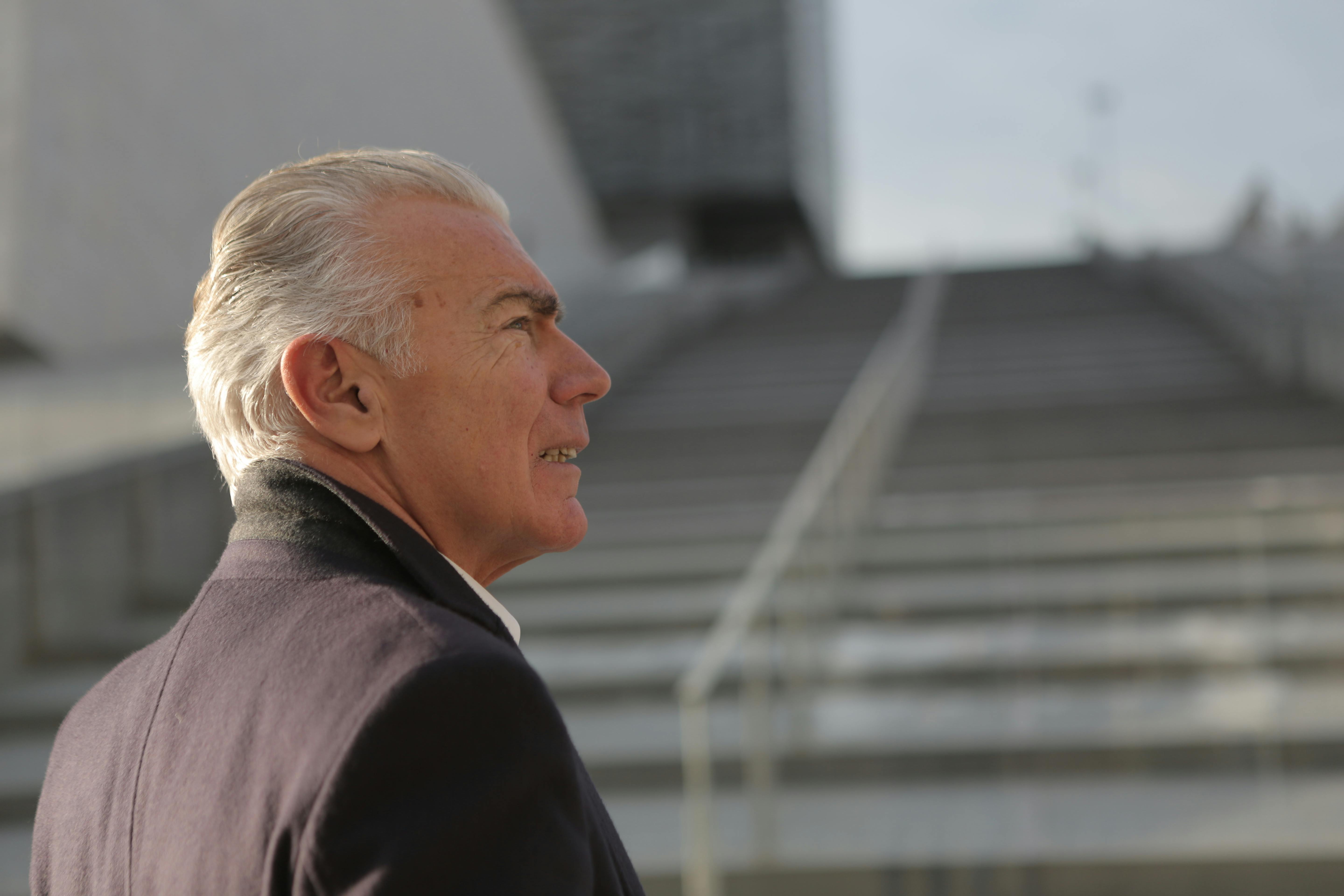 Senior man standing near the staircase | Source: Pexels