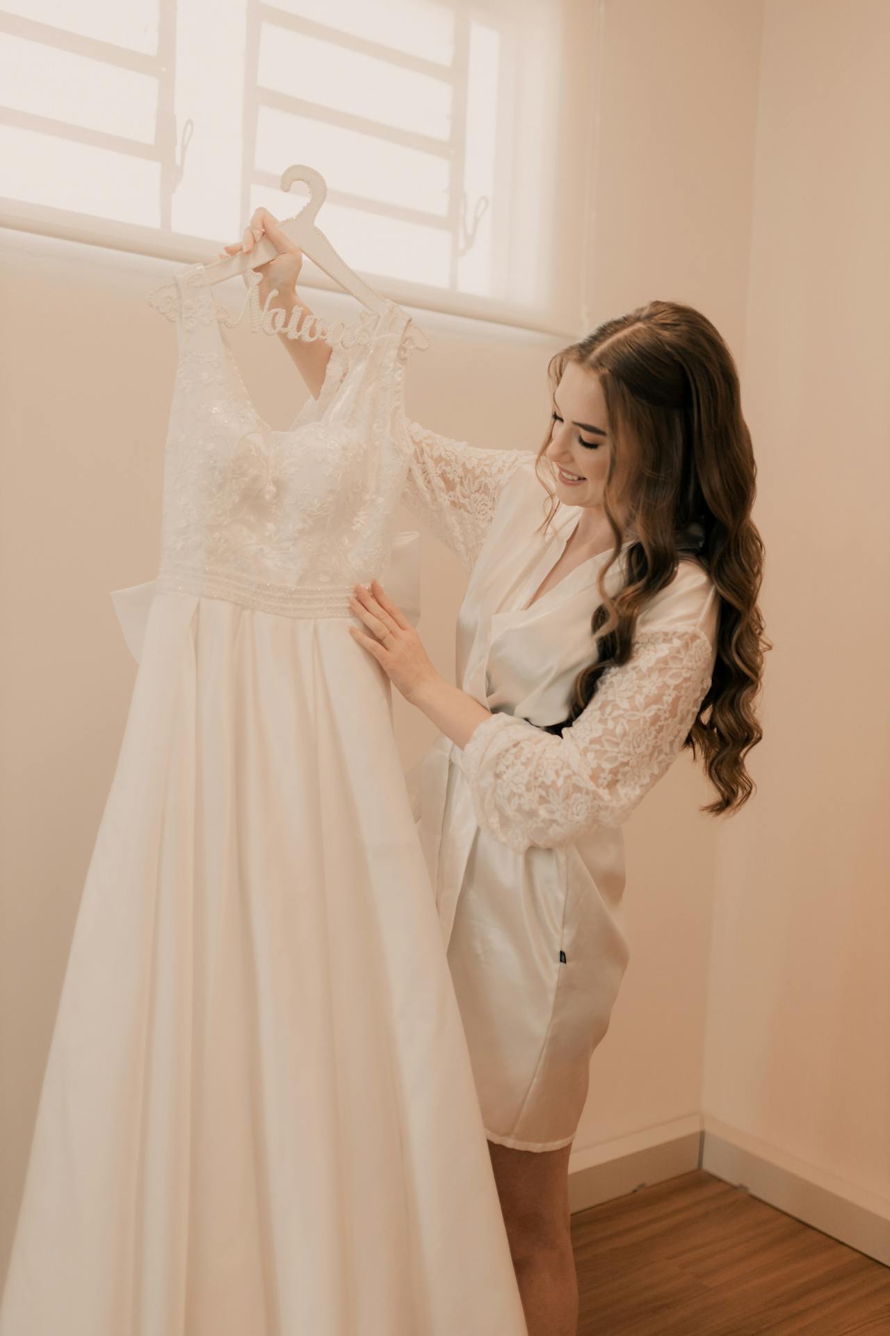 A delighted woman admiring her wedding dress | Source: Pexels