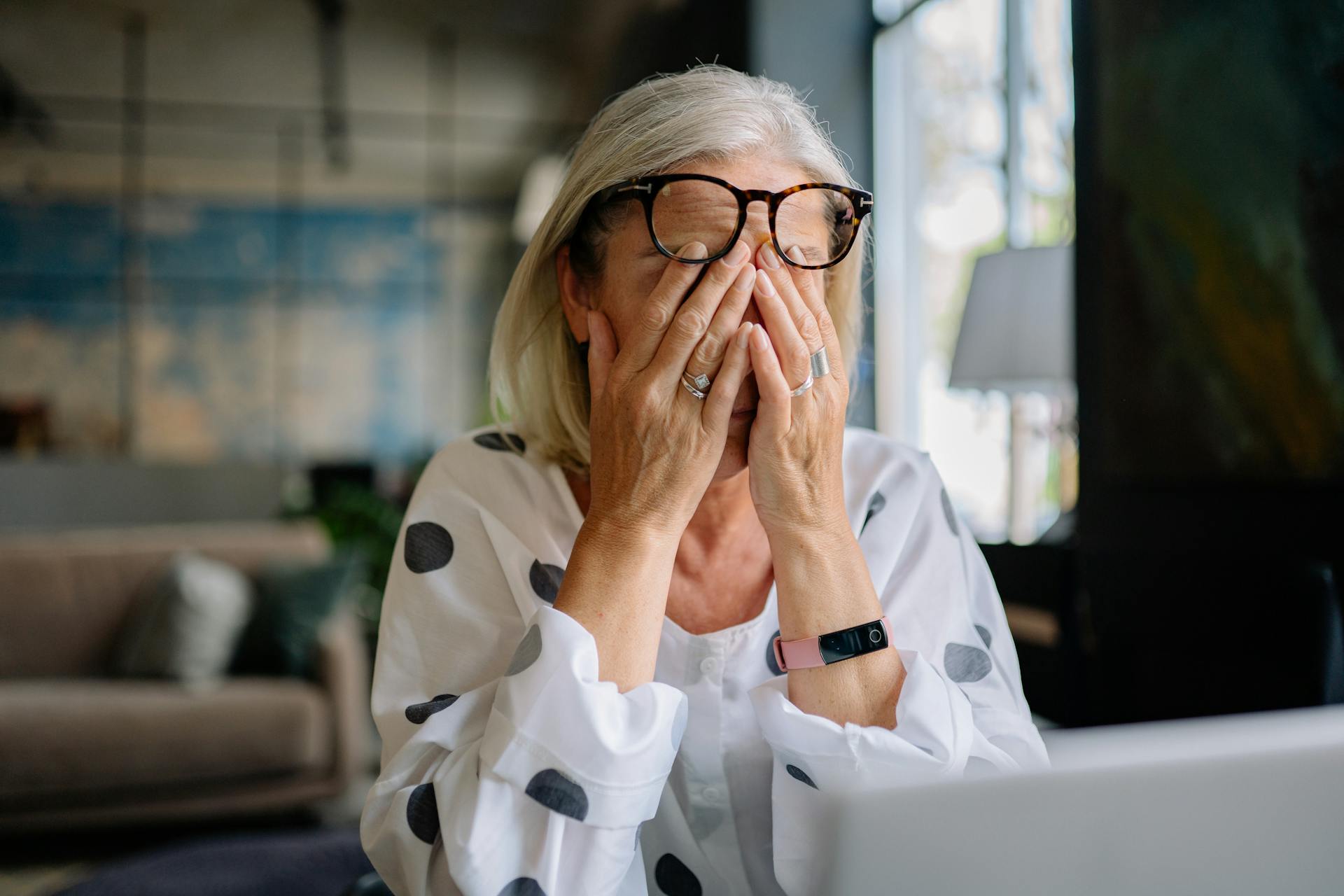 A distraught woman covering her face with her hands | Source: Pexels