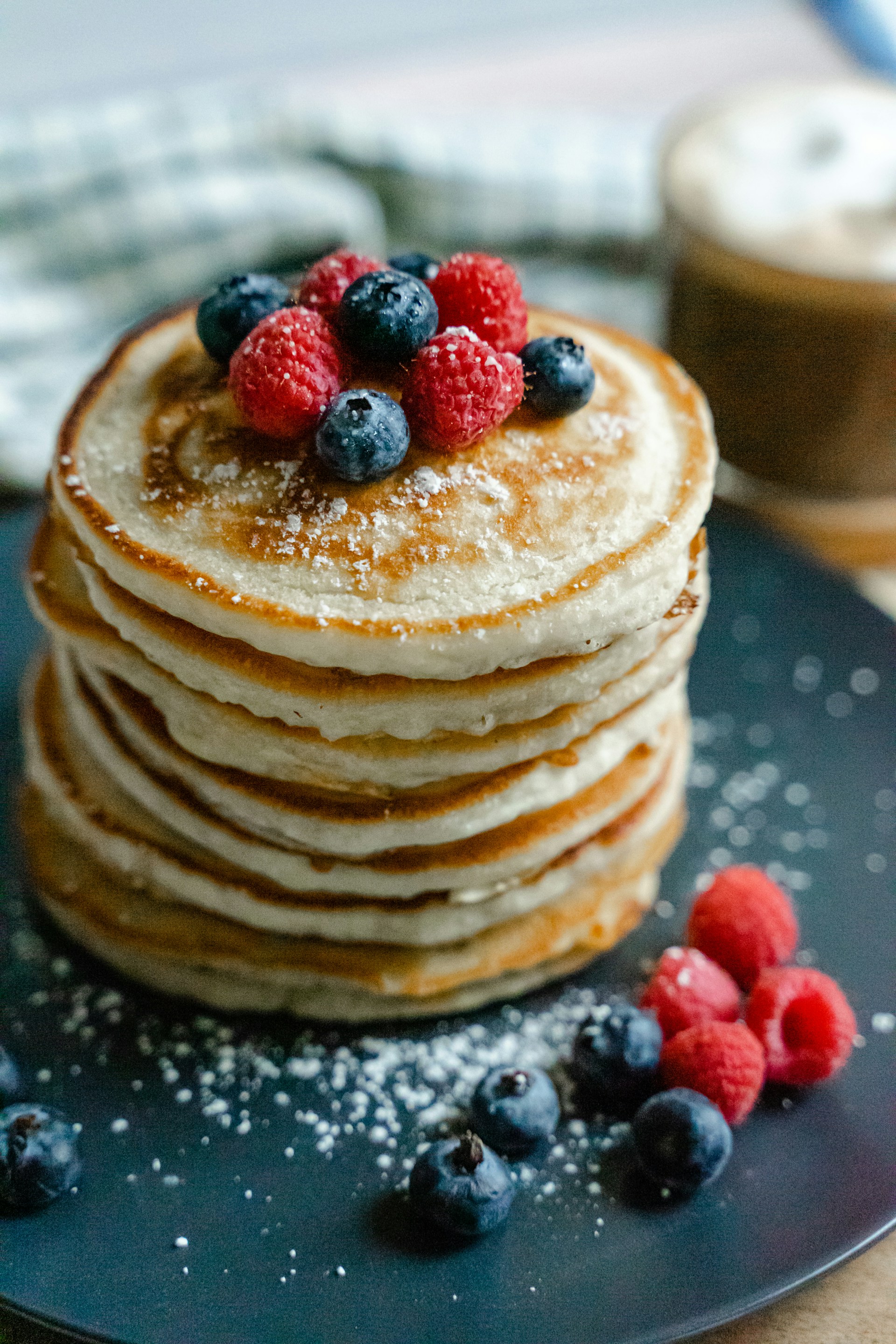 A plate of delicious pancakes with blueberries and raspberries | Source: Unsplash