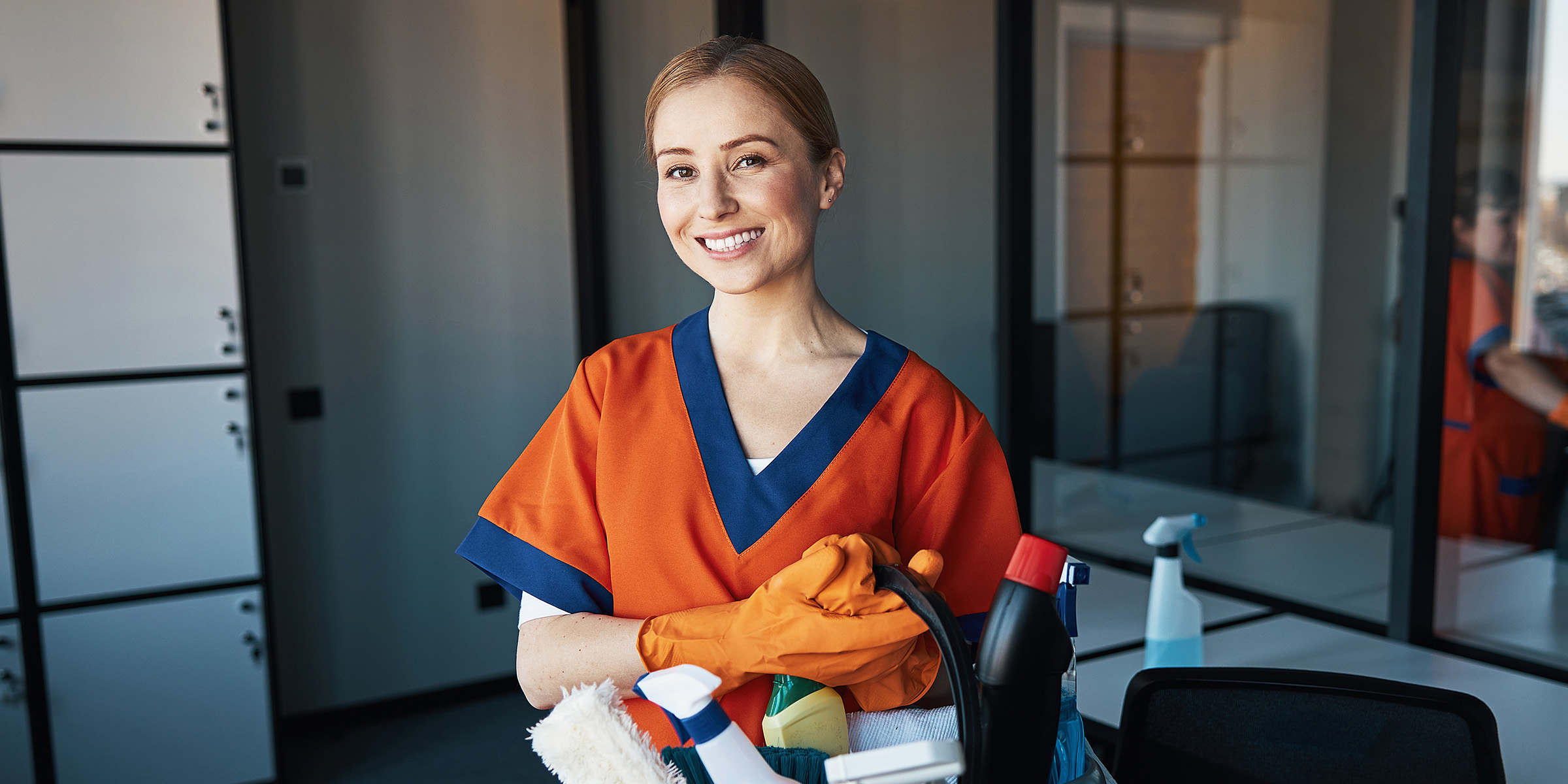 A woman holding cleaning supplies | Source: Shutterstock