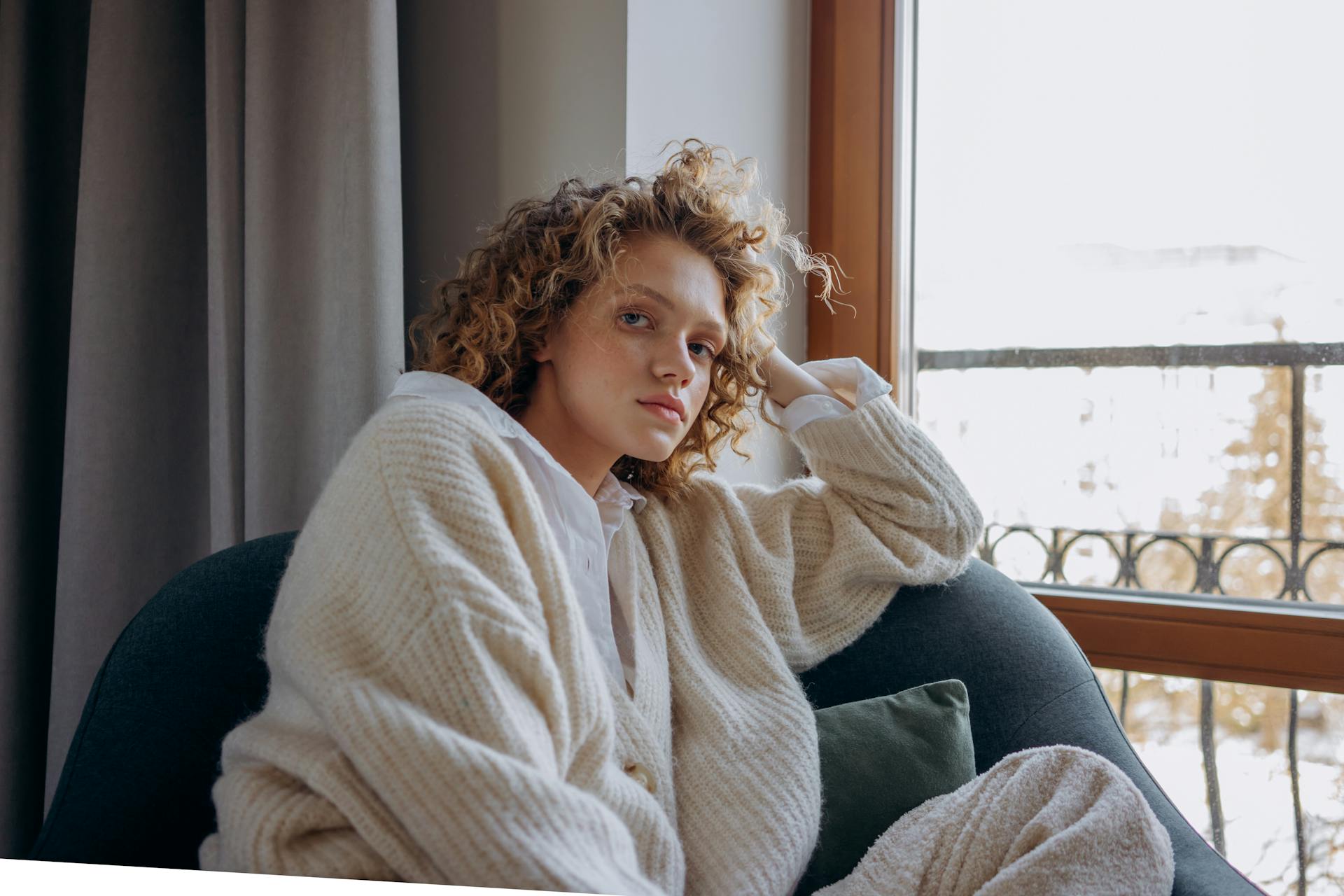 A woman sitting on an armchair | Source: Pexels