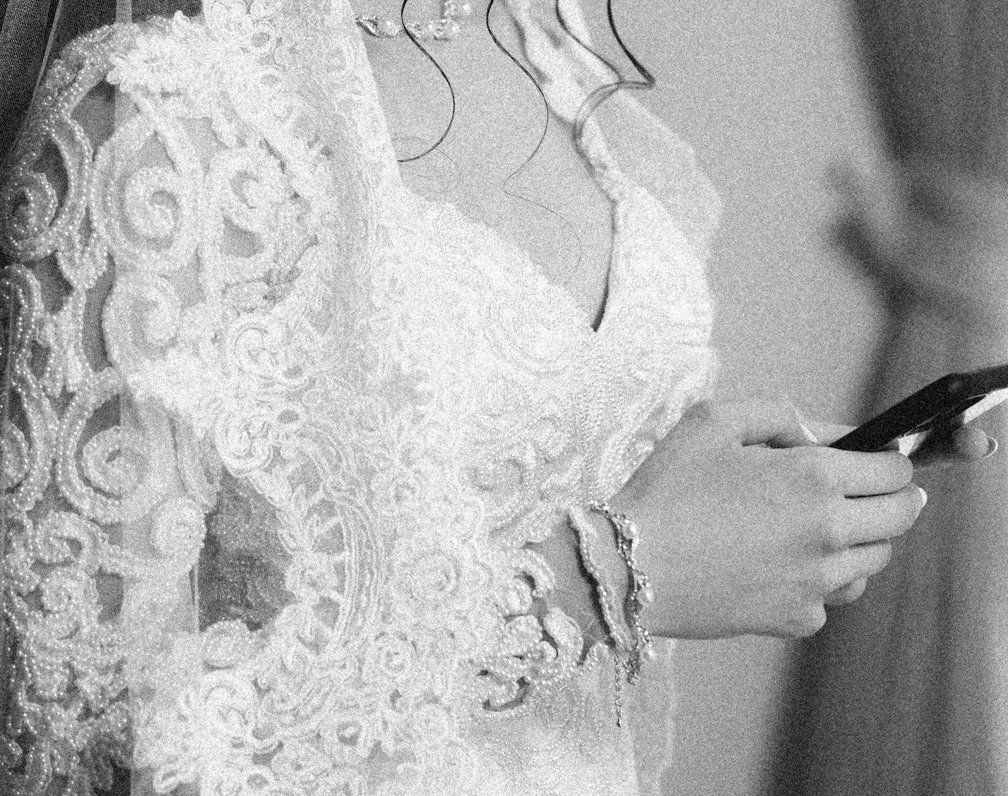 Grayscale shot of a bride holding her phone | Source: Pexels