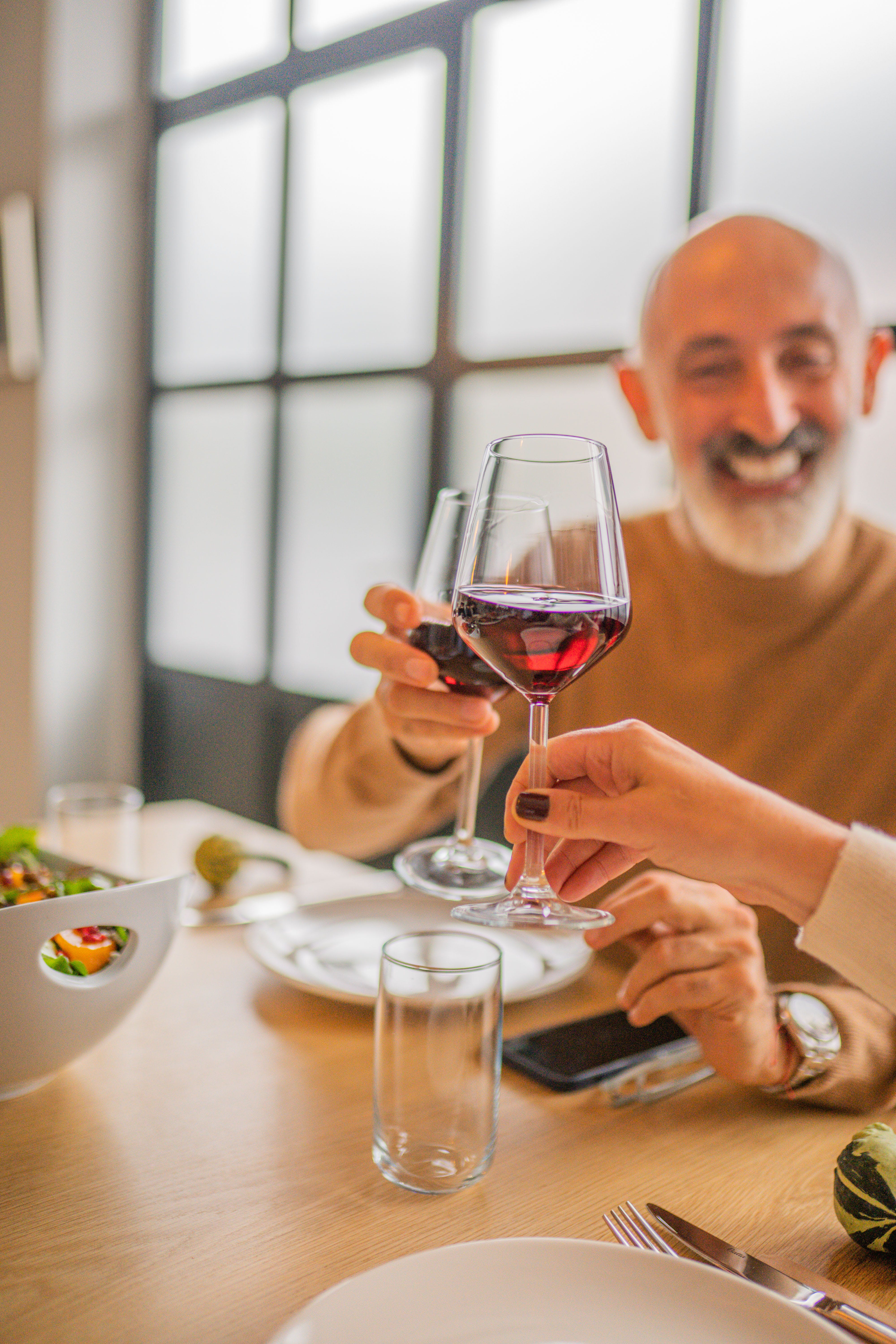 Happy man having a toast while holding a glass of red wine | Source: Pexels