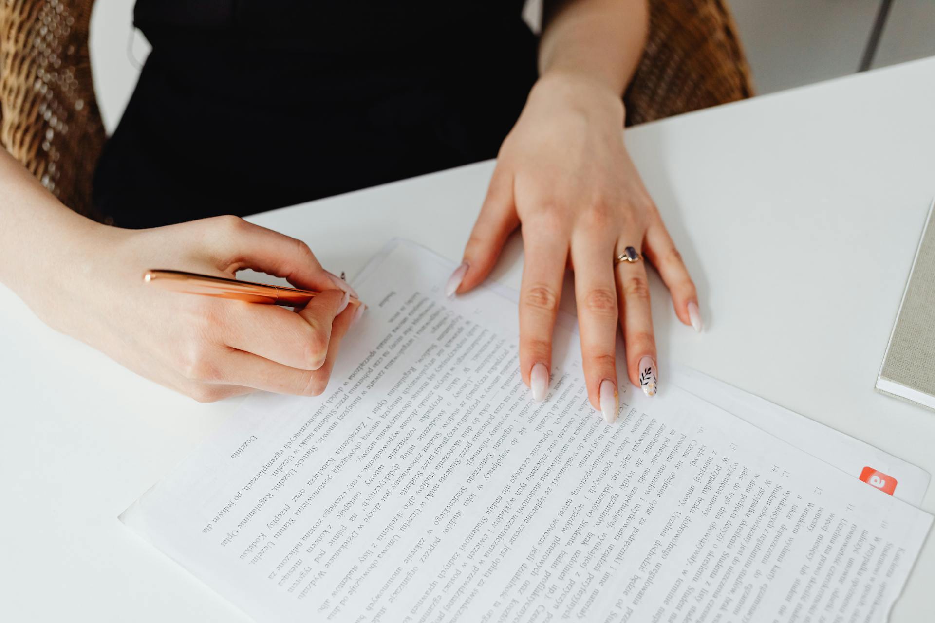 A woman signing a document | Source: Pexels