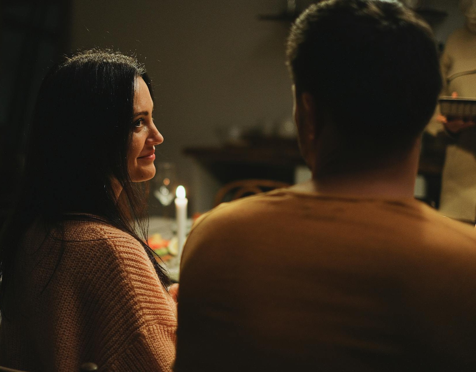 A couple smiling at each other during dinner | Source: Pexels