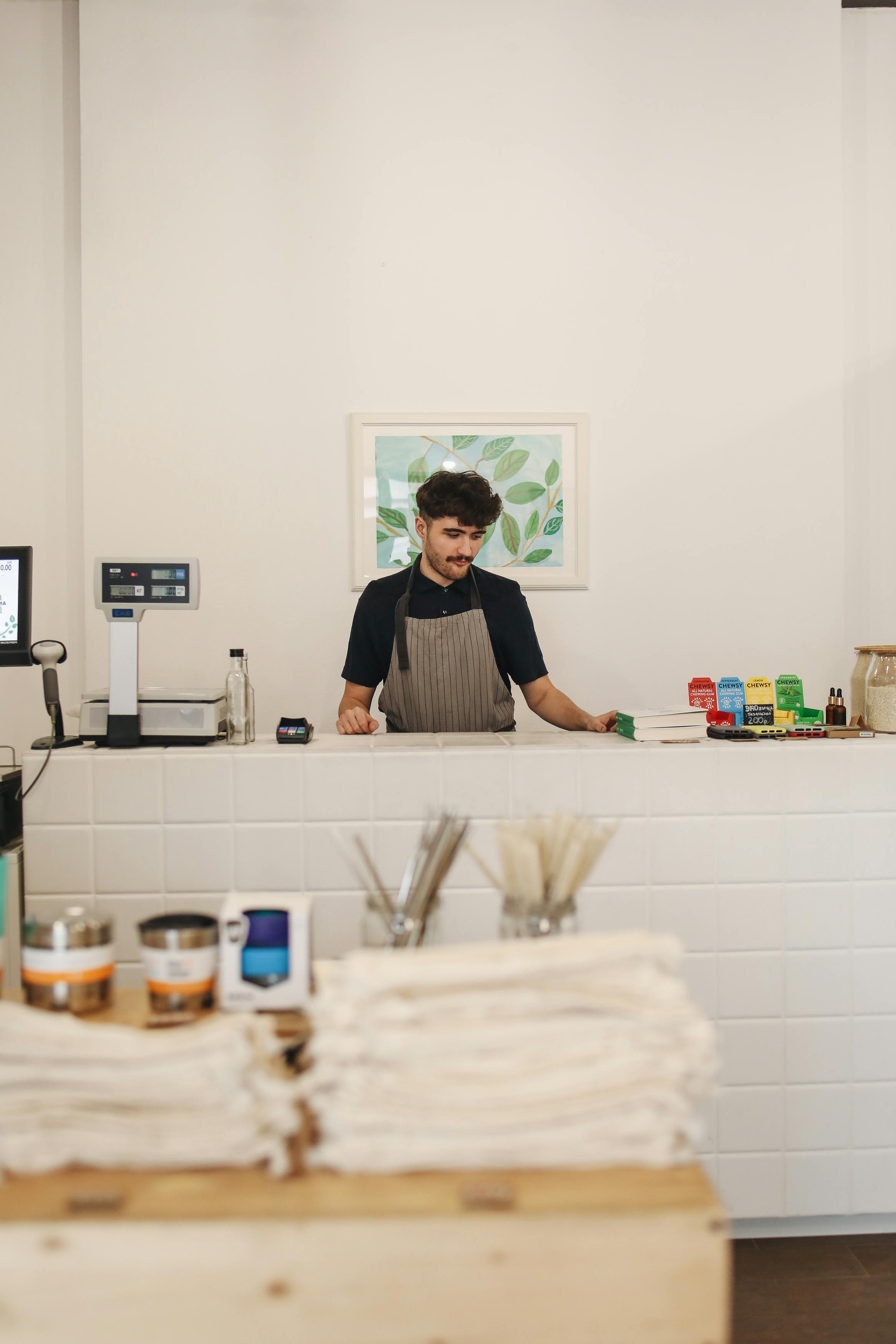 A store owner behind the counter | Source: Pexels