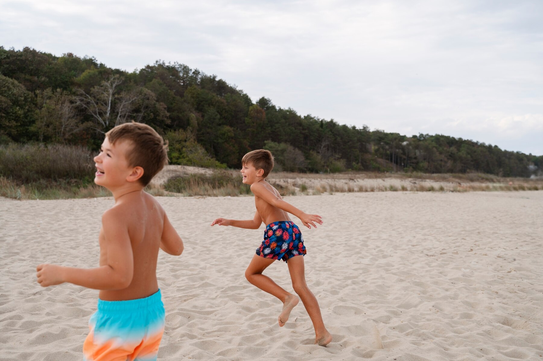 Boys playing on a beach | Source: Freepik