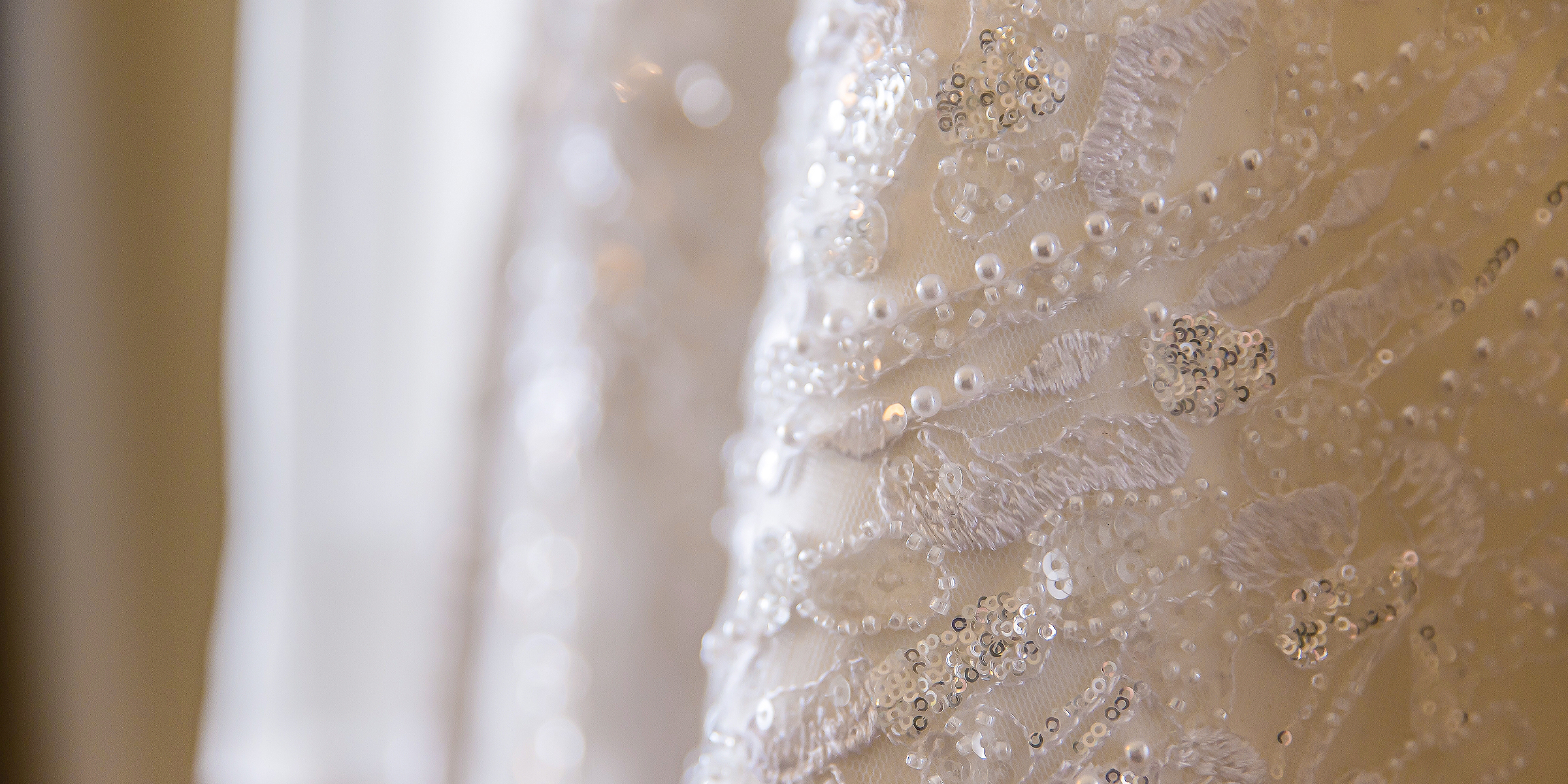 A close-up of an exquisite wedding dress with pearls | Source: Shutterstock