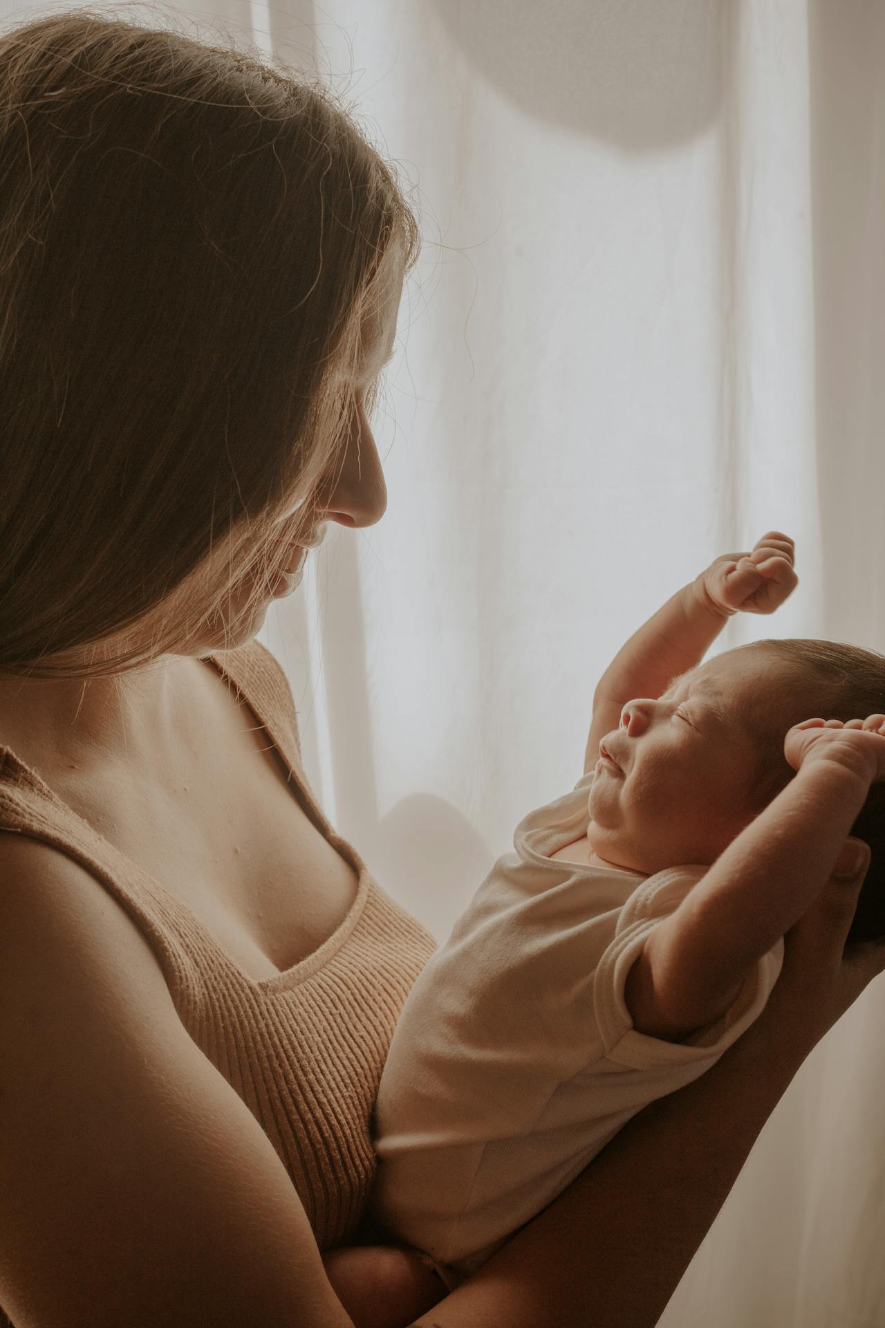 A woman holding a newborn baby | Source: Pexels