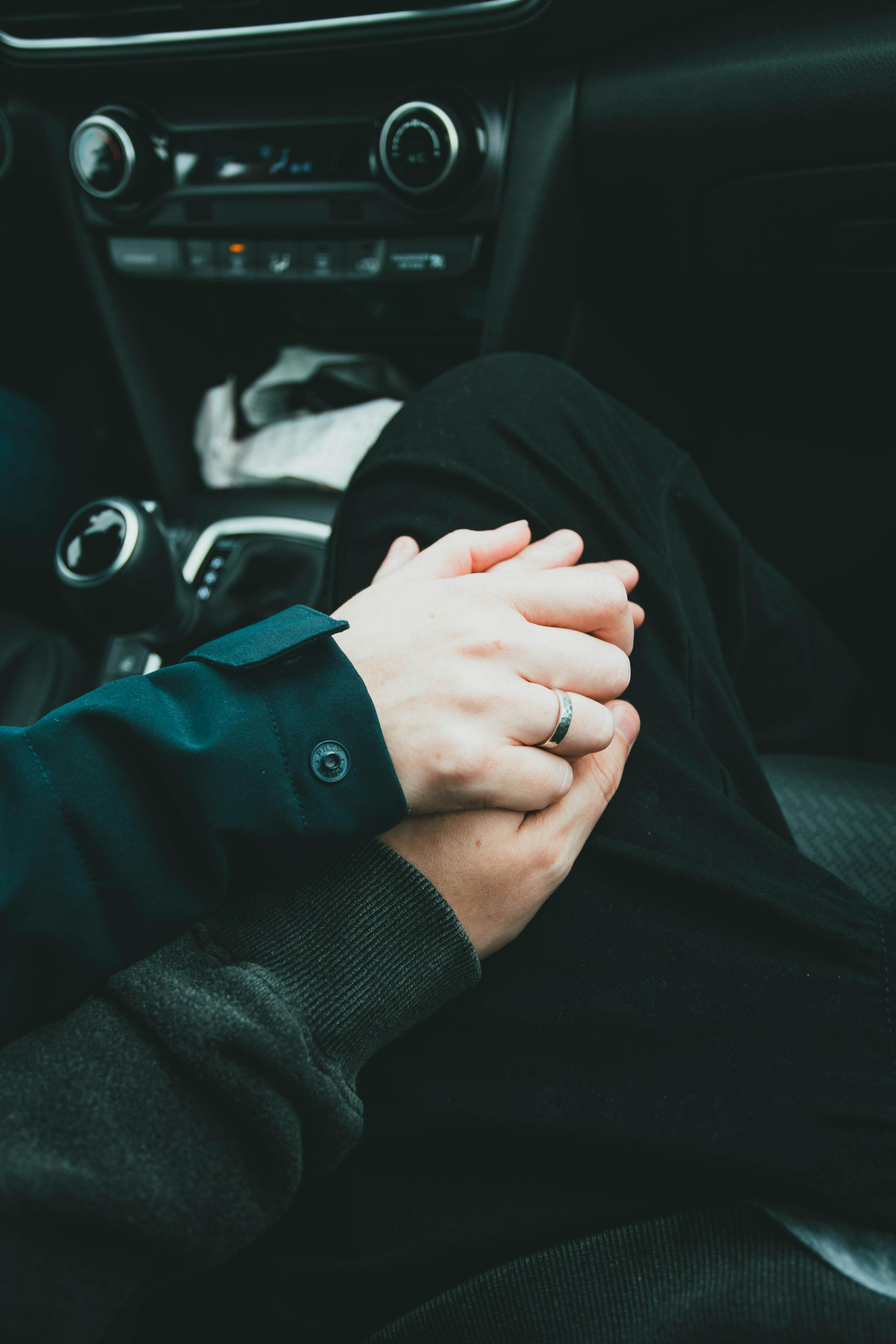 Una pareja cogida de la mano en el coche | Fuente: Pexels