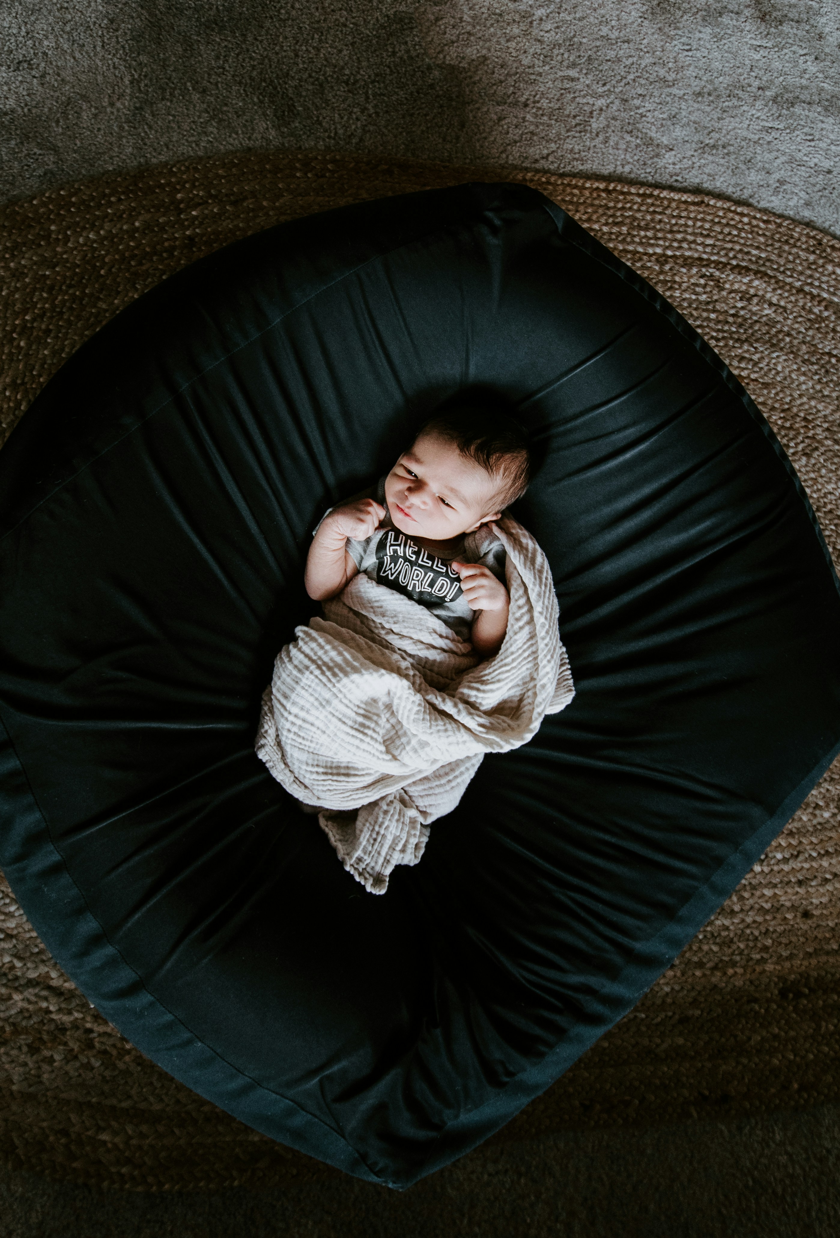 A baby boy on a cushion | Source: Unsplash