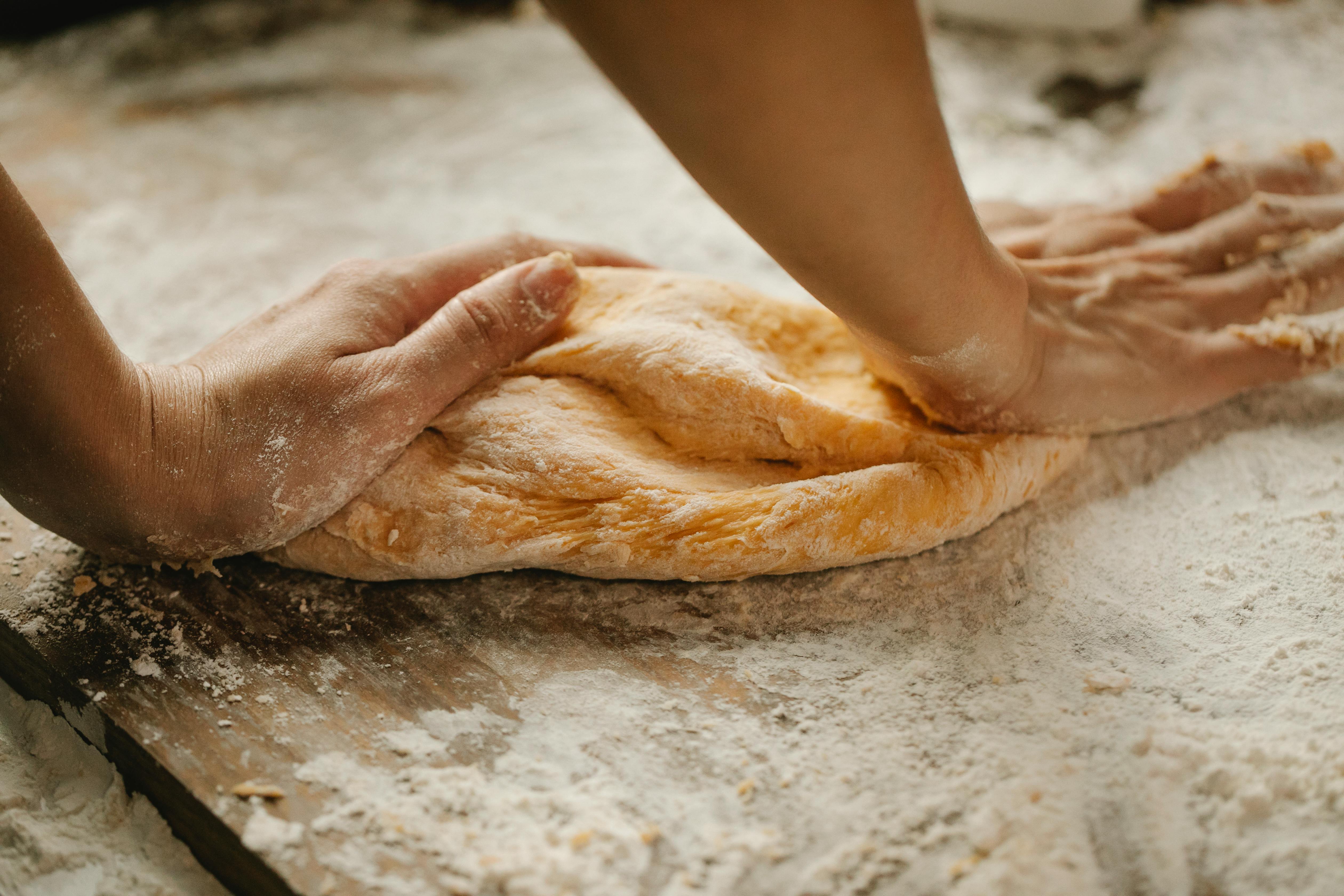 A woman's hands kneading dough | Source: Pexels