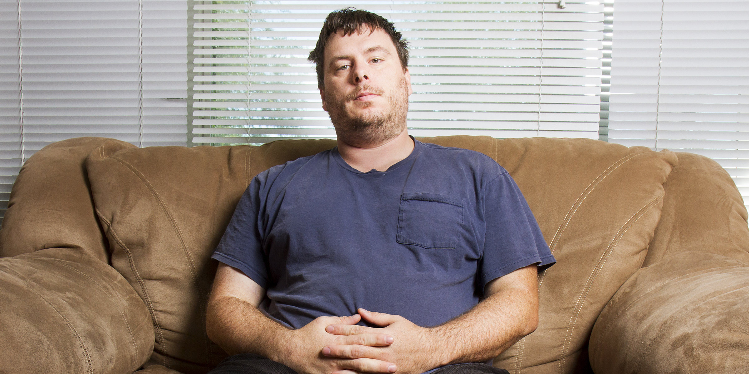 Man relaxing on the couch | Source: Shutterstock