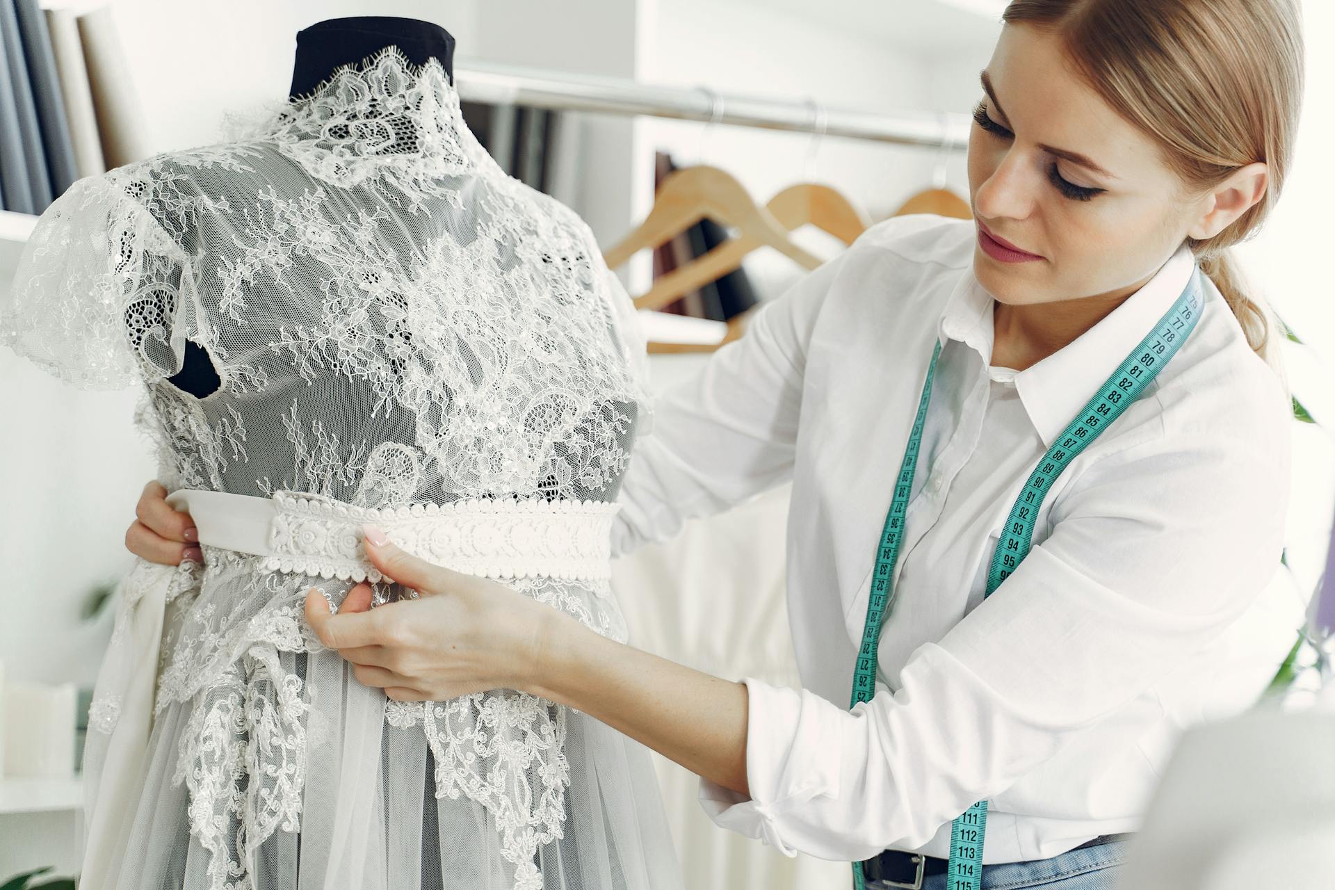 A seamstress working on a lace dress | Source: Pexels