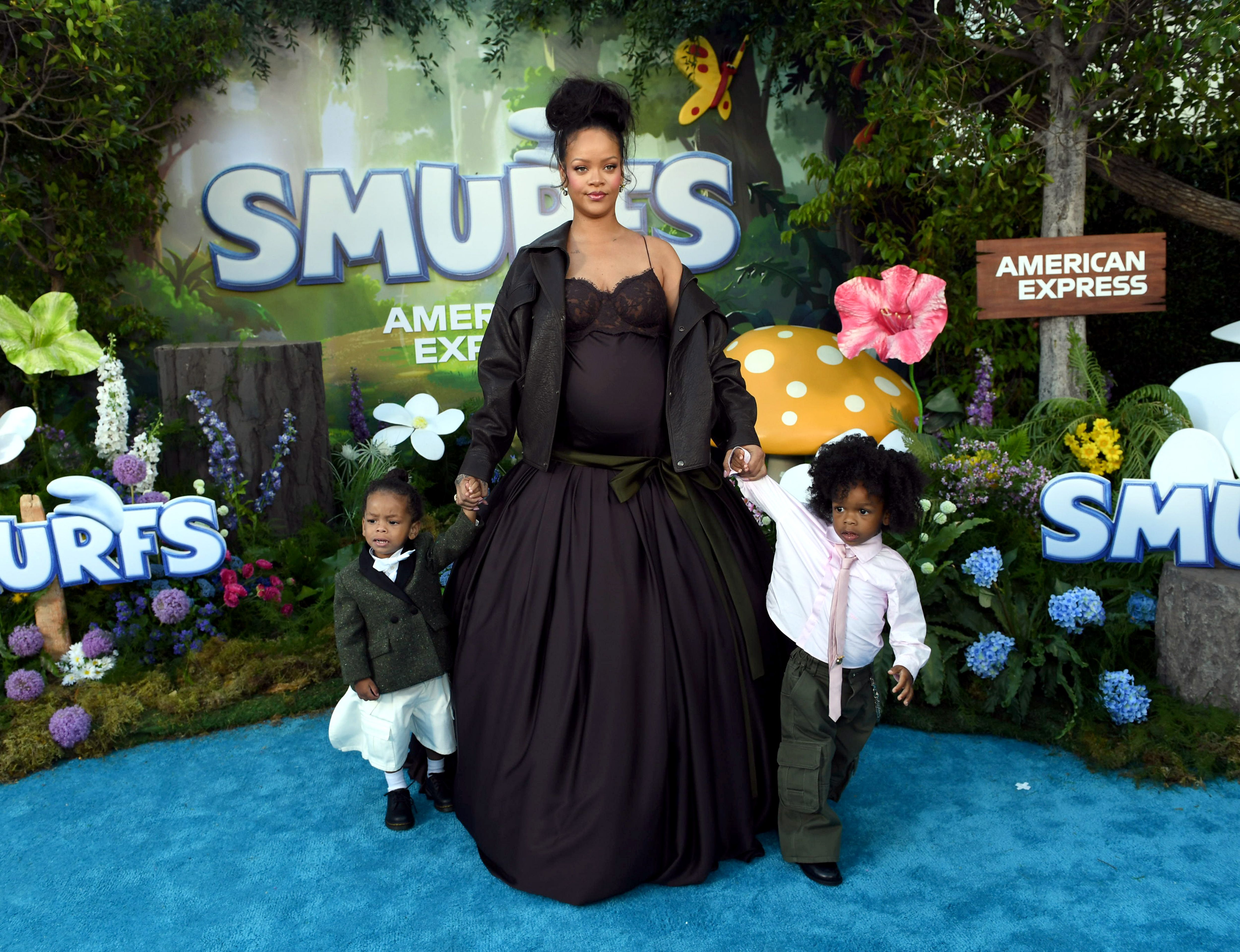 Rihanna holding hands with her sons Riot Rose Mayers and RZA Athelston Mayers at the Los Angeles premiere of ''Smurfs'' at Paramount Pictures Studios, July 13, 2025 | Source: Getty Images