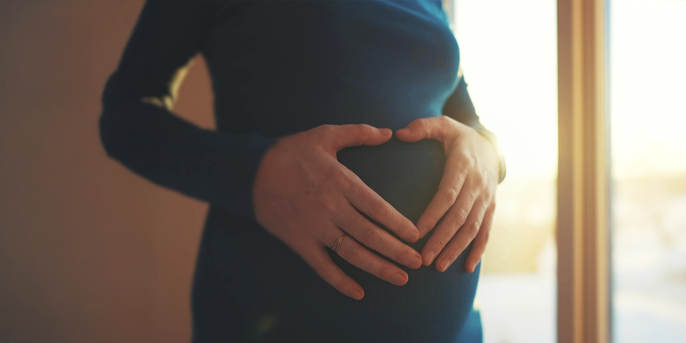 Woman holding her pregnant belly | Source: Shutterstock