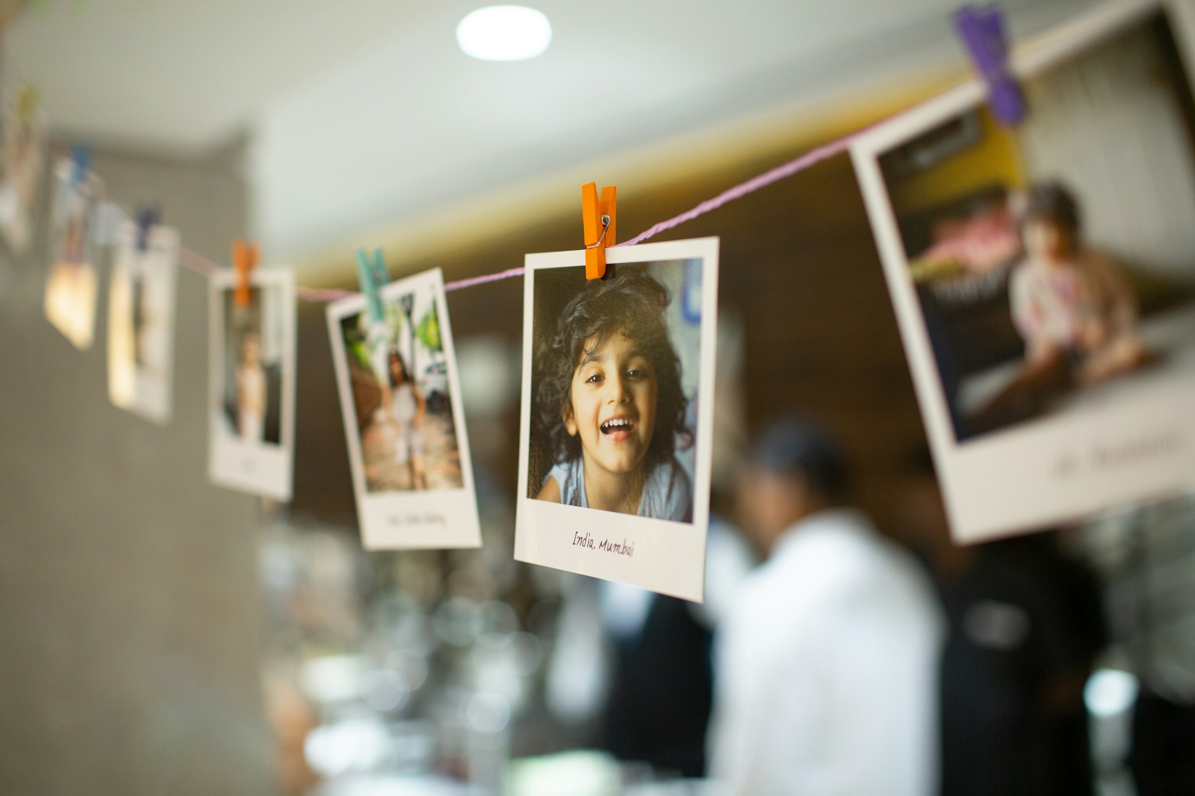 Children's photos hanging on a wire | Source: Unsplash