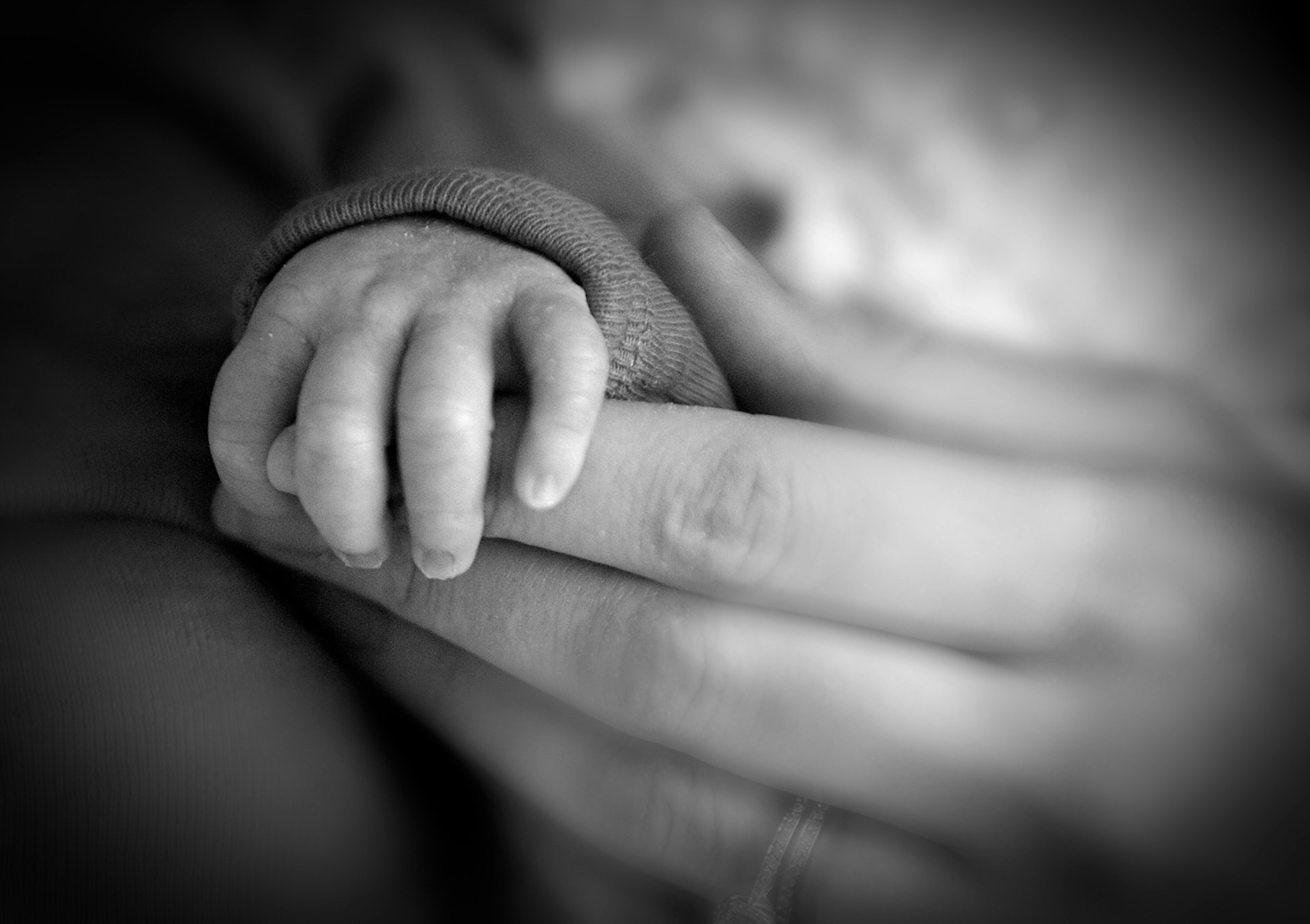 A mother holding her baby's hand | Source: Unsplash