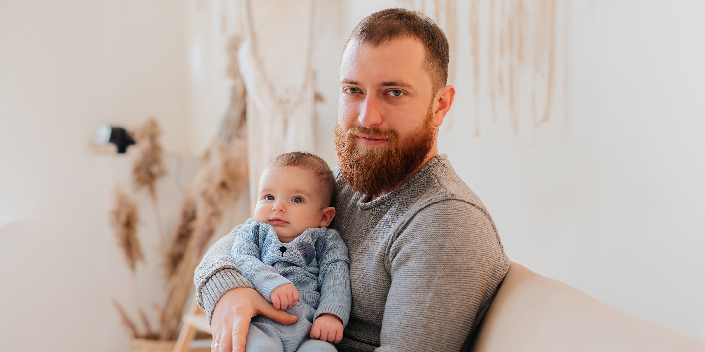 A man holding a baby | Source: Shutterstock