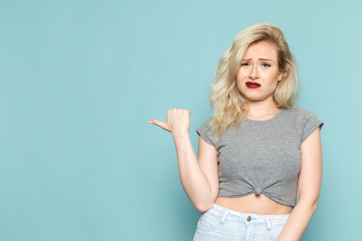 A young woman looking displeased | Source: Freepik