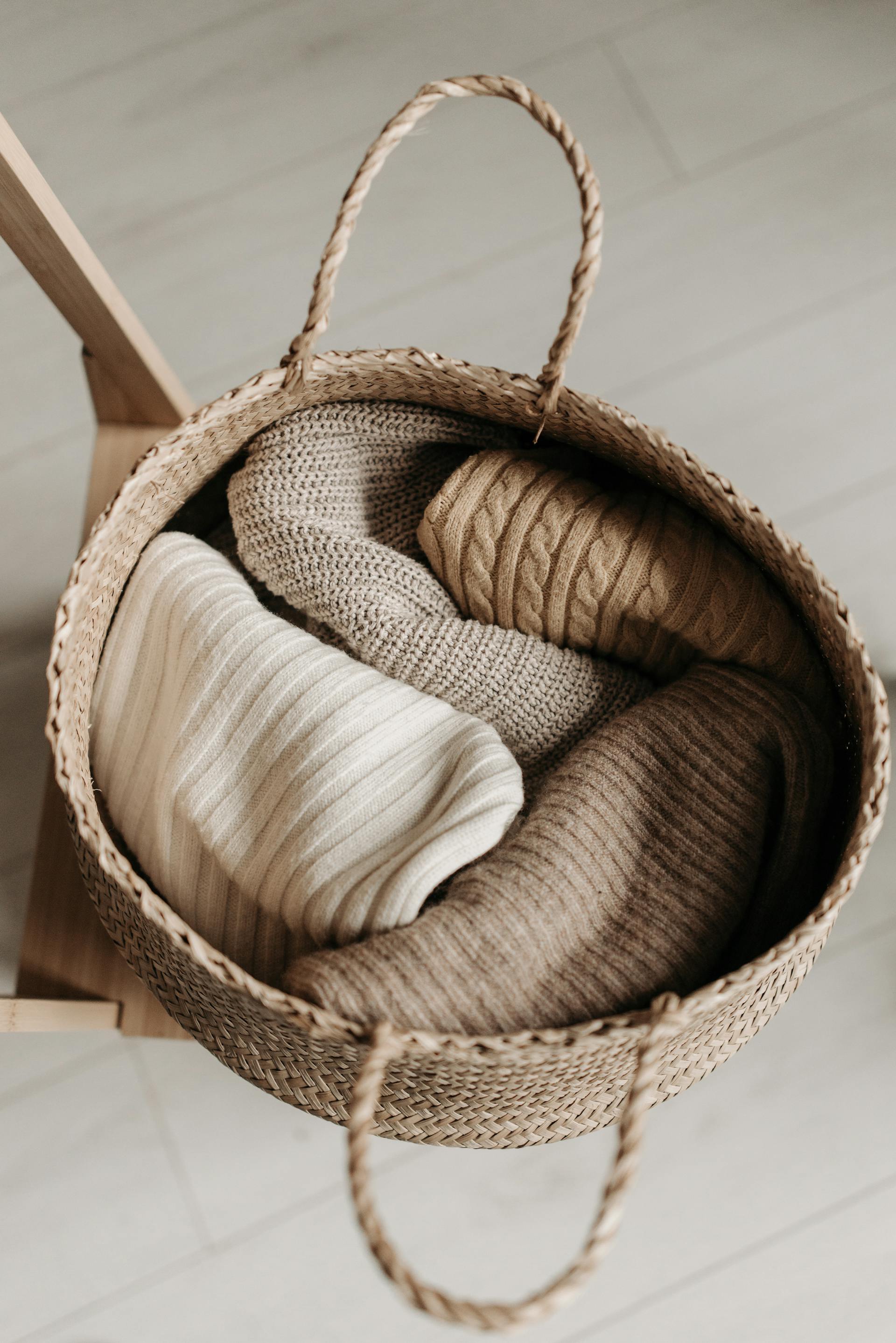 Cardigans lying in a basket | Source: Pexels