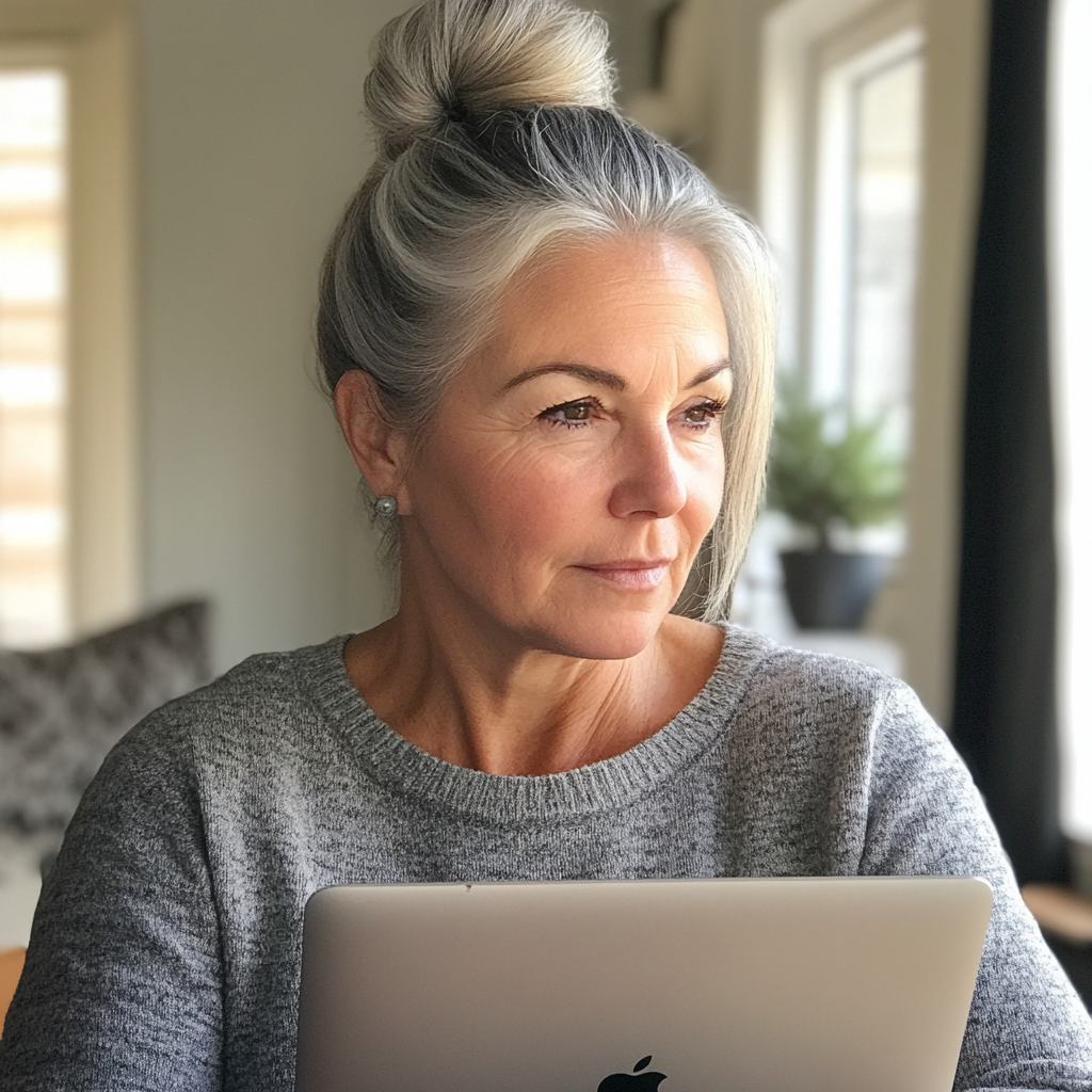 A woman using a laptop | Source: Midjourney