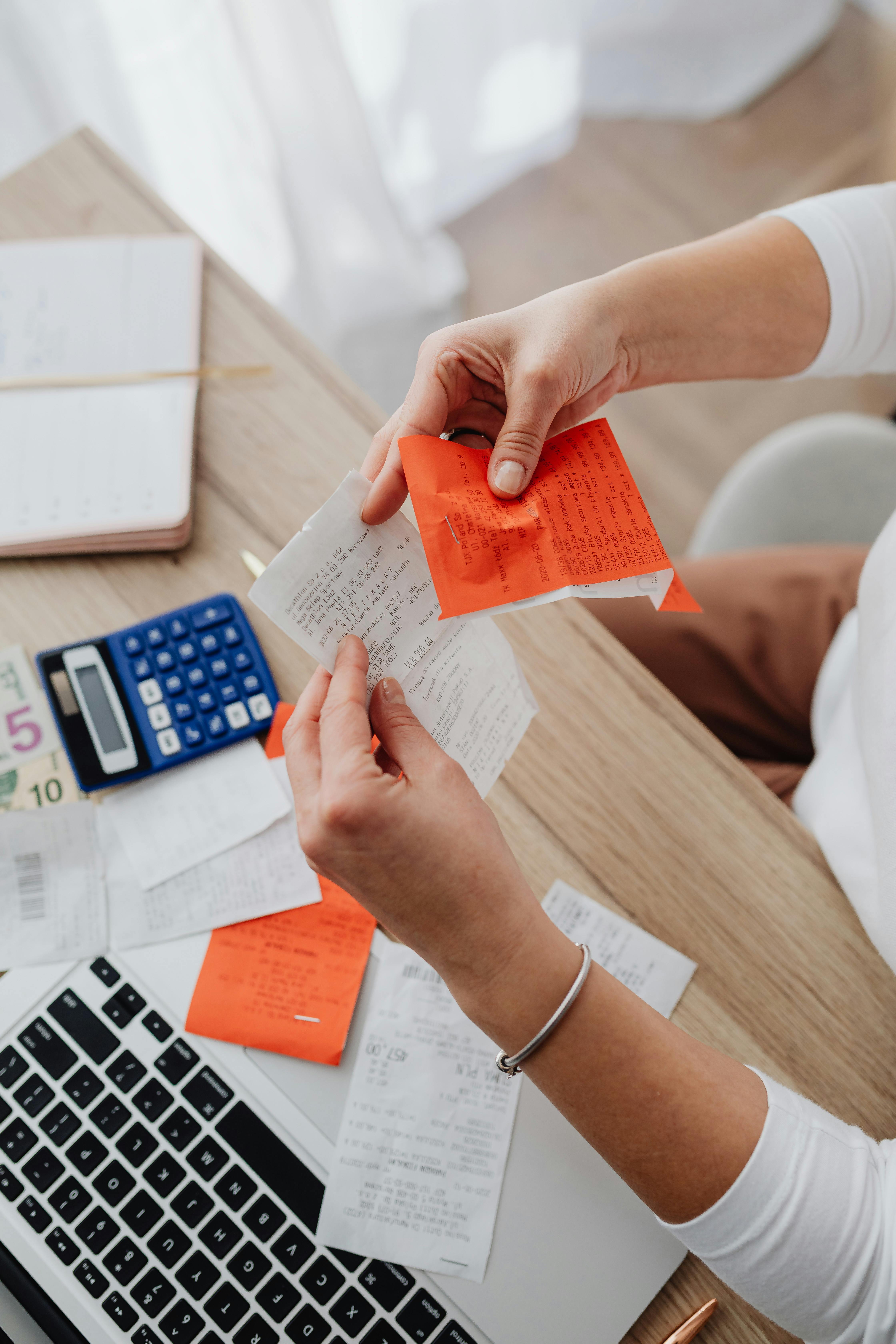 A woman going through receipts | Source: Pexels
