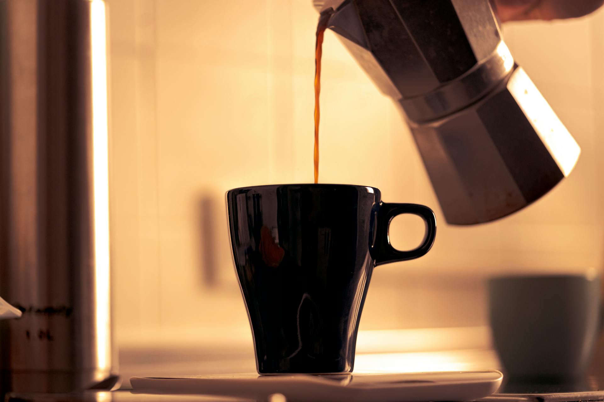 A person pouring coffee | Source: Pexels