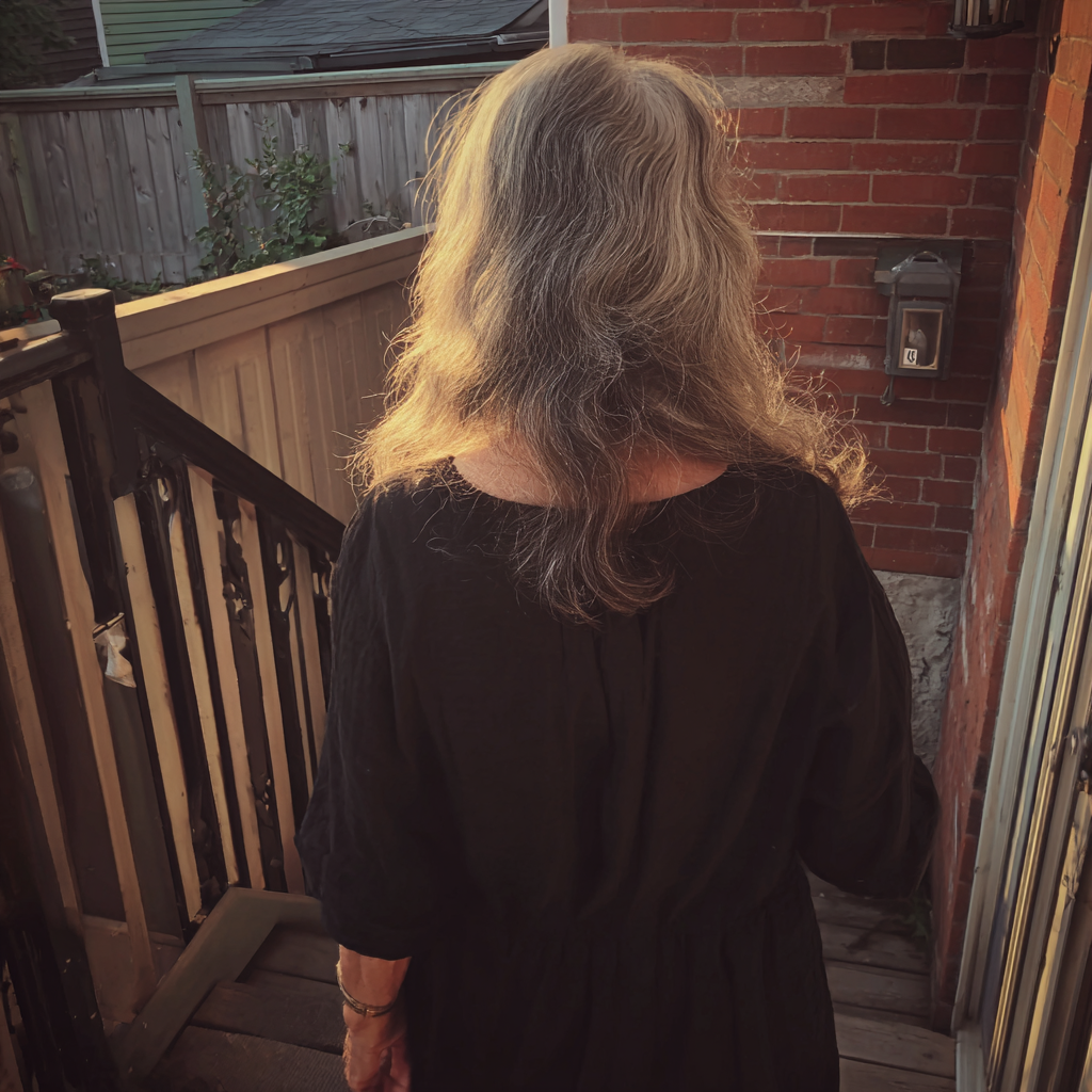 A woman walking down porch steps | Source: Midjourney