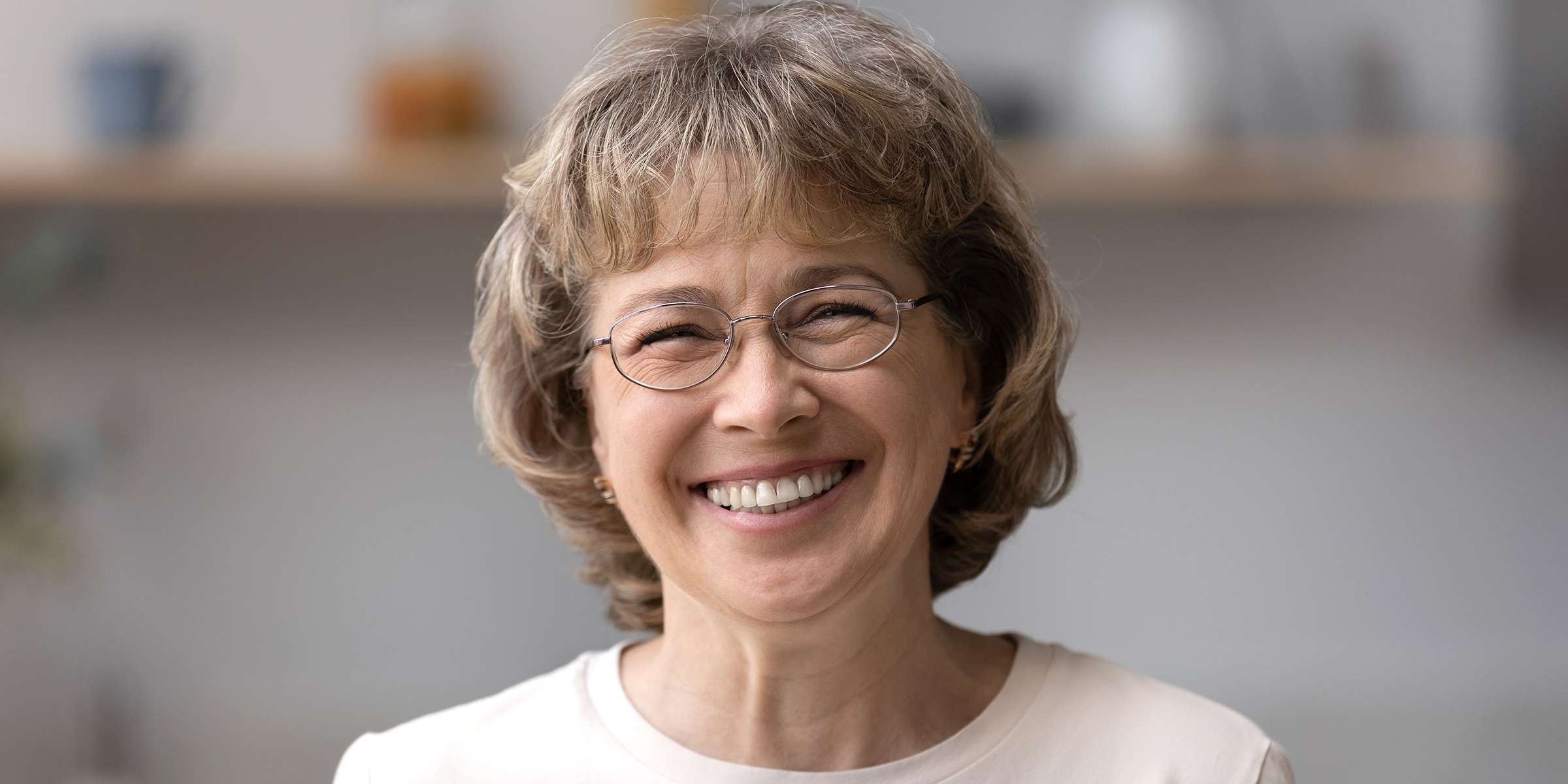 A smiling woman wearing glasses | Source: Shutterstock