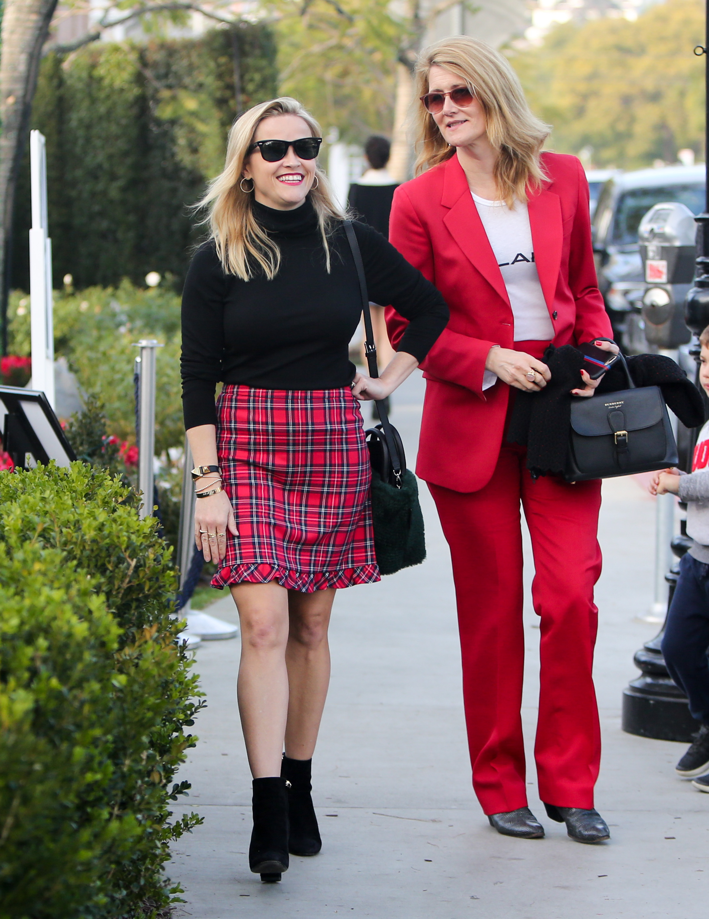 Reese Witherspoon and Laura Dern spotted twinning in red on December 22, 2018 | Source: Getty Images