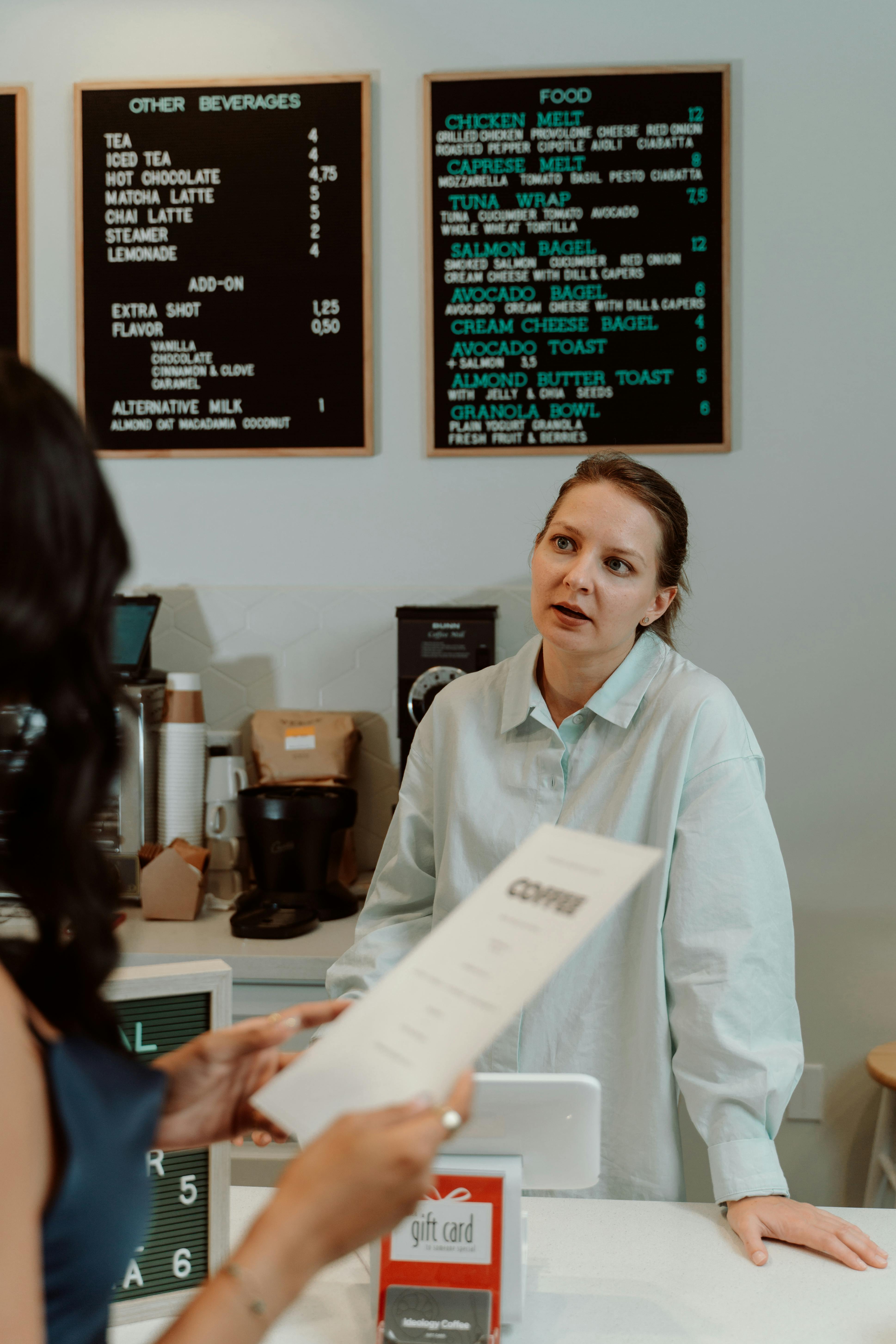 A woman serving a customer | Source: Pexels