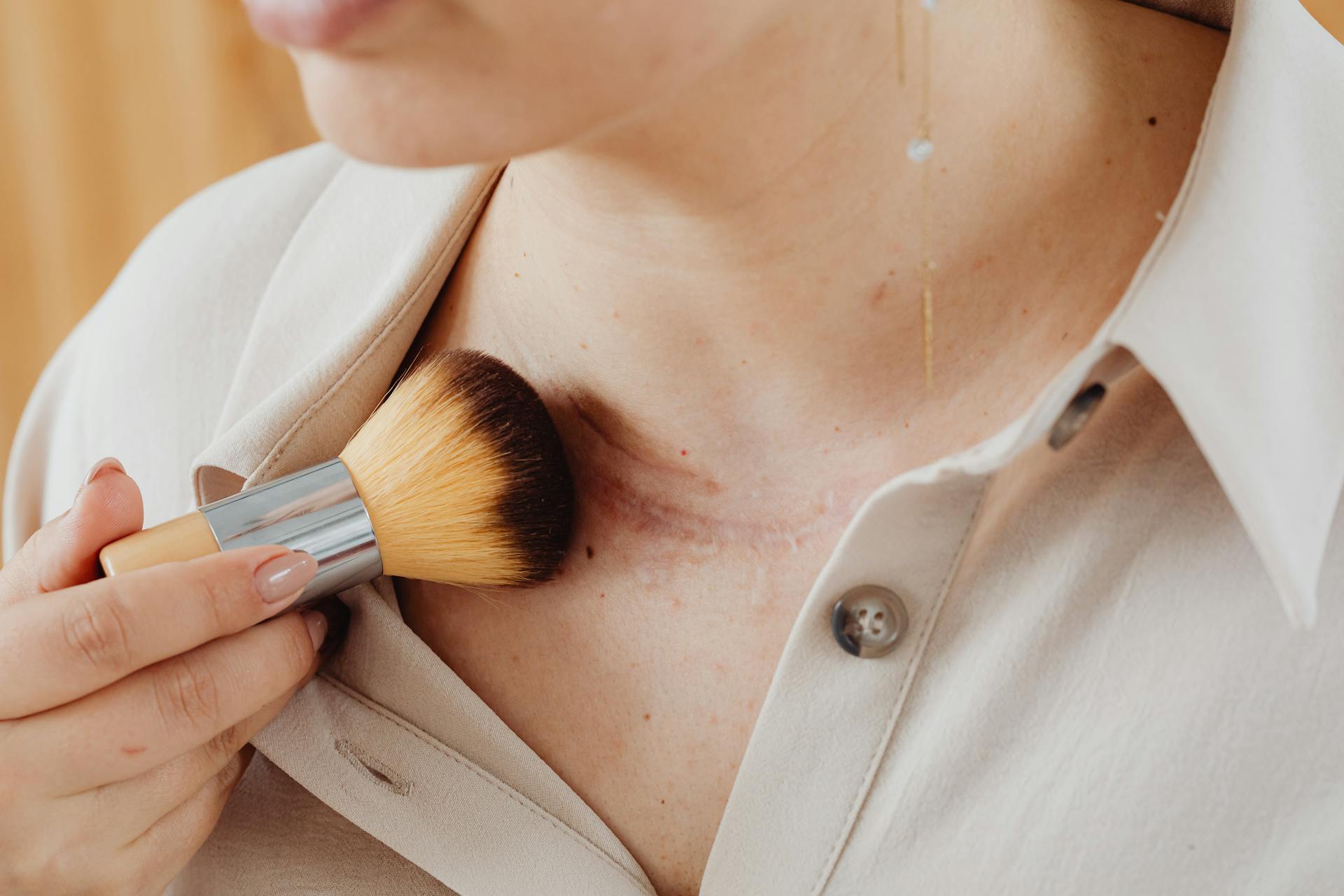 A woman concealing her scar with makeup | Source: Pexels