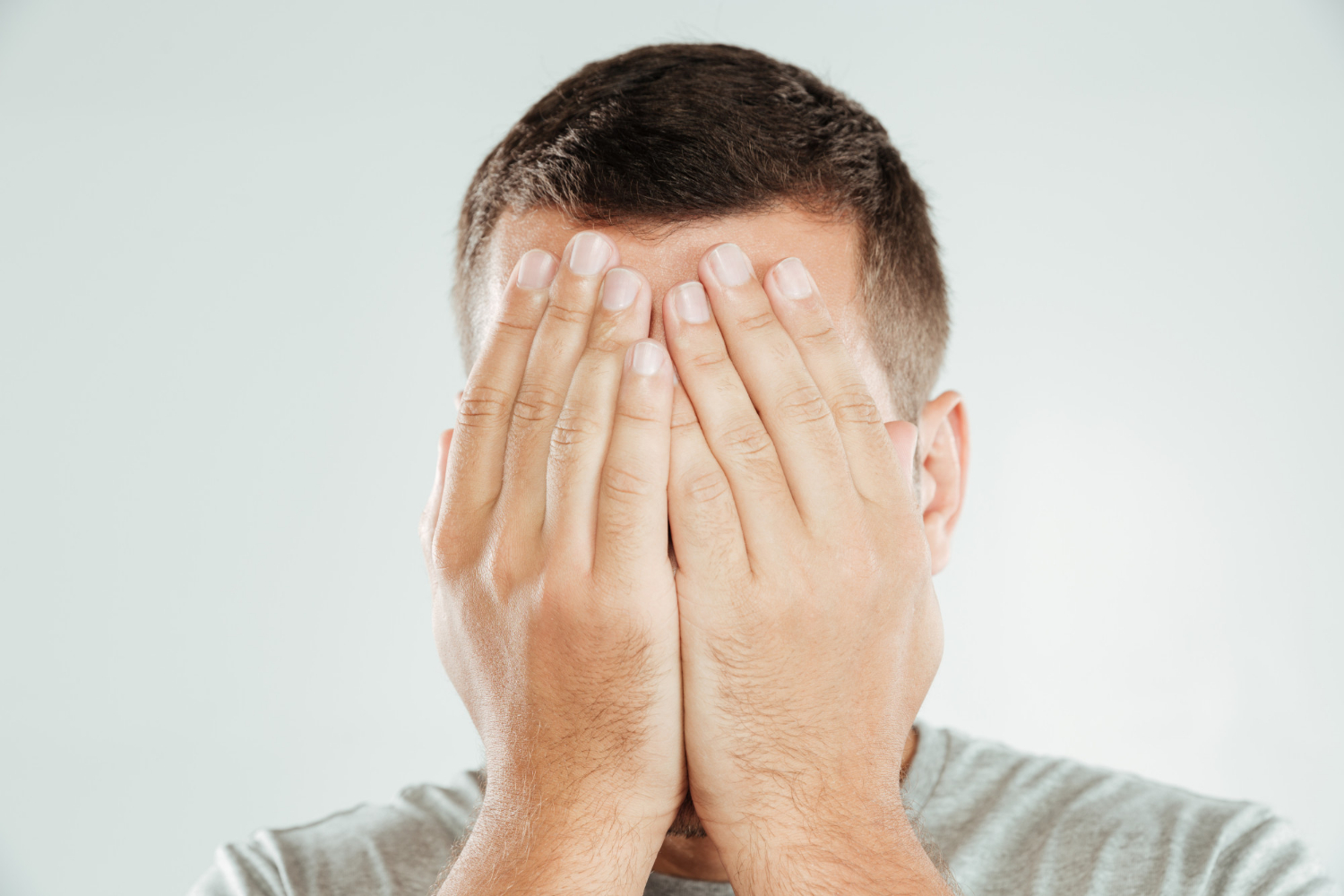 A man covering his face | Source: Freepik
