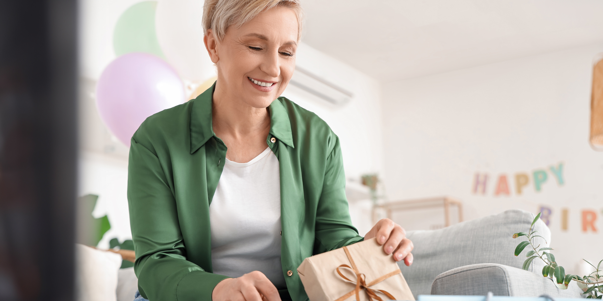A woman holding a gift box | Source: Shutterstock