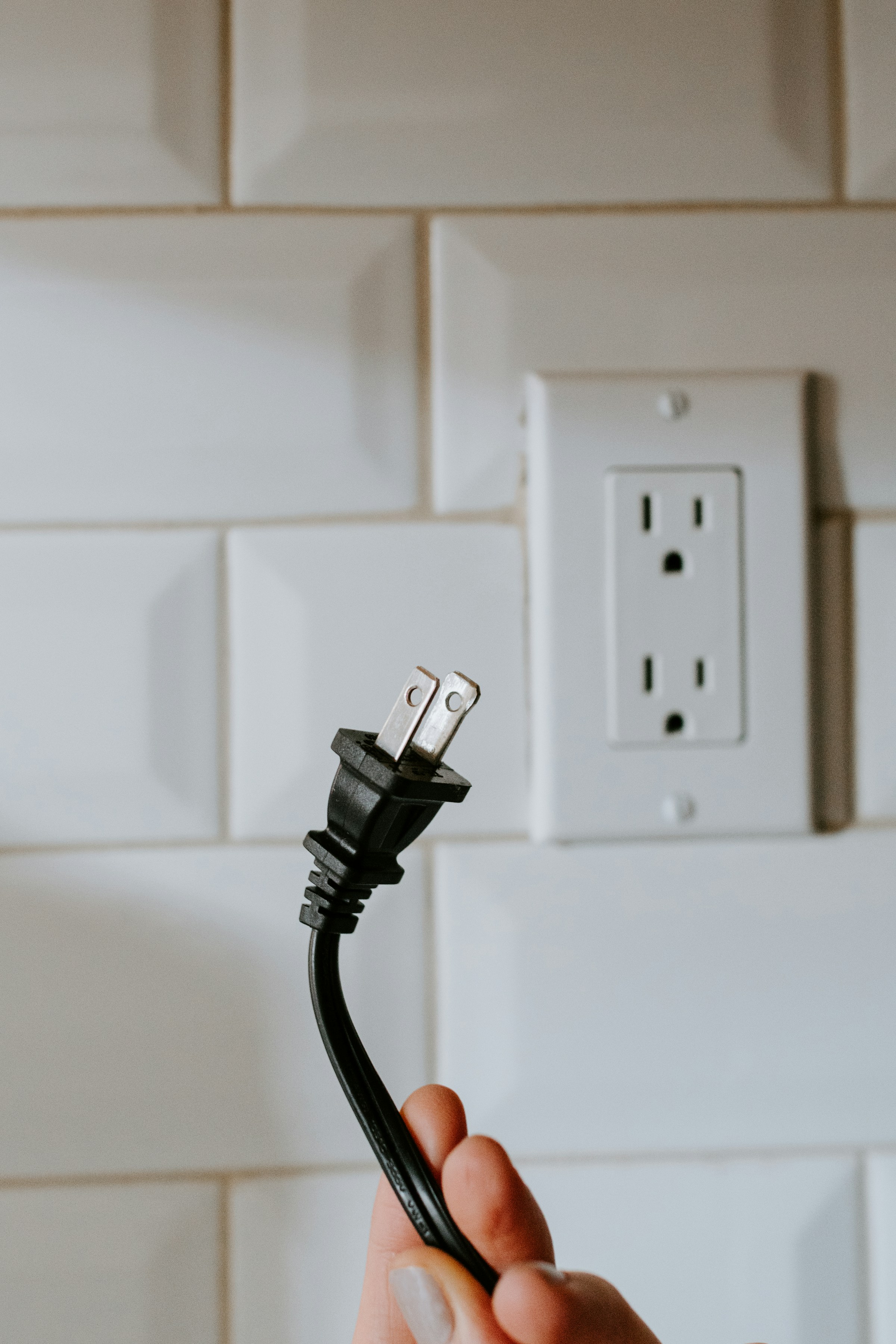 A woman holding a plug | Source: Unsplash