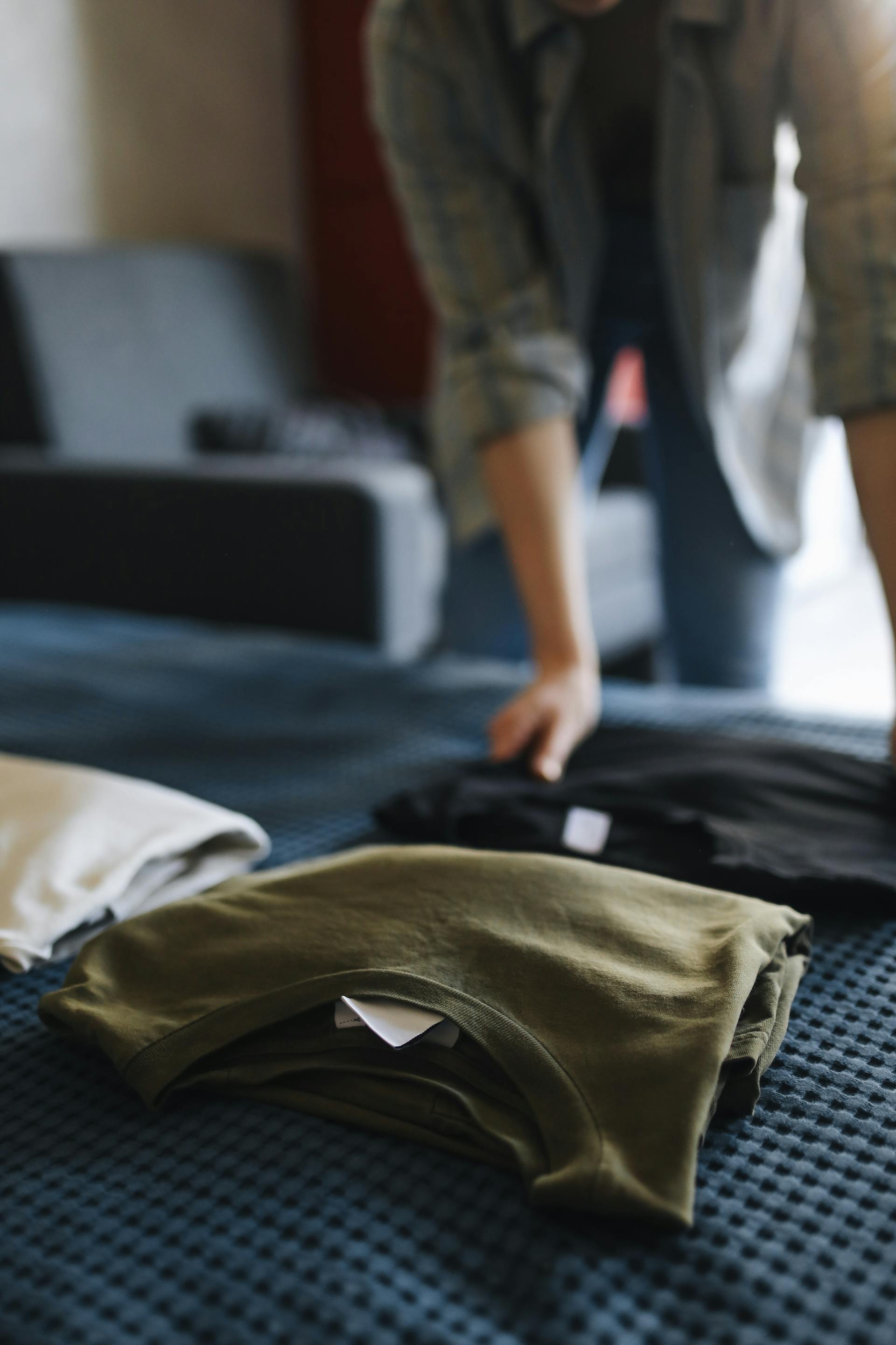 A person folding laundry | Source: Pexels