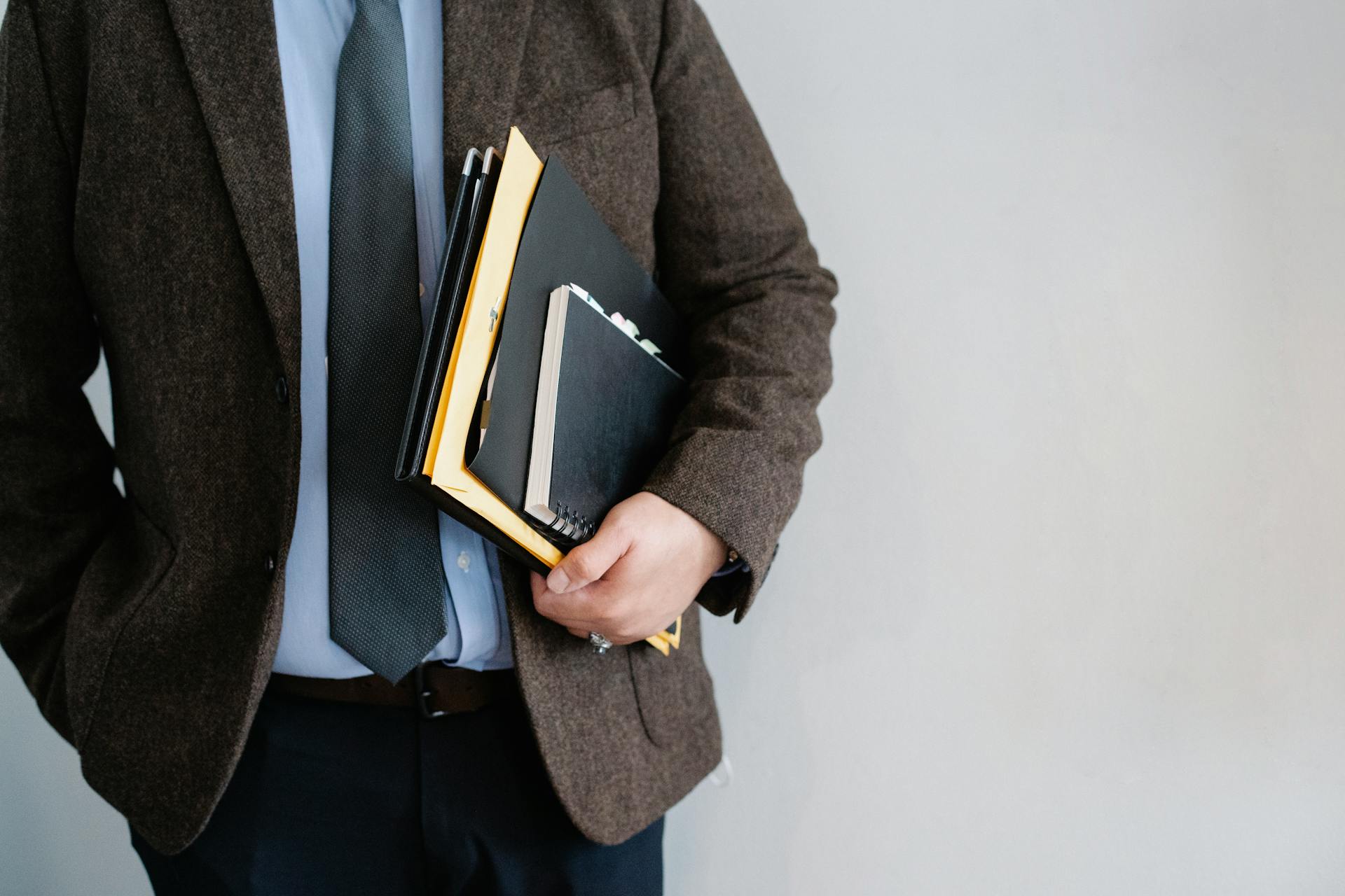 A man holding a set of files | Source: Pexels