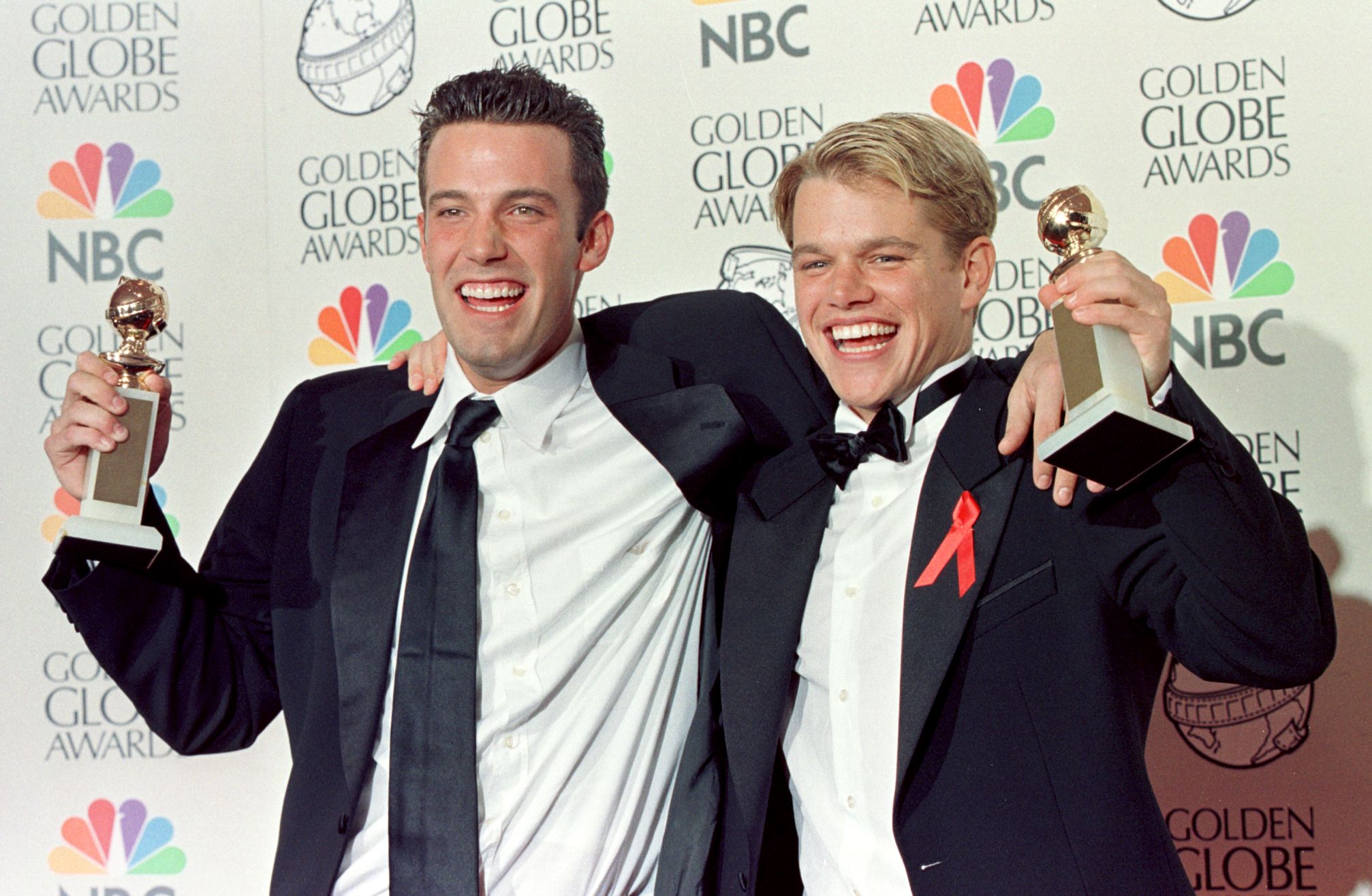 Co-writers Ben Affleck and Matt Damon posing with their Golden Globe award for Best Screenplay for "Good Will Hunting" at the 55th Annual Golden Globe Awards in 1998 | Source: Getty Images