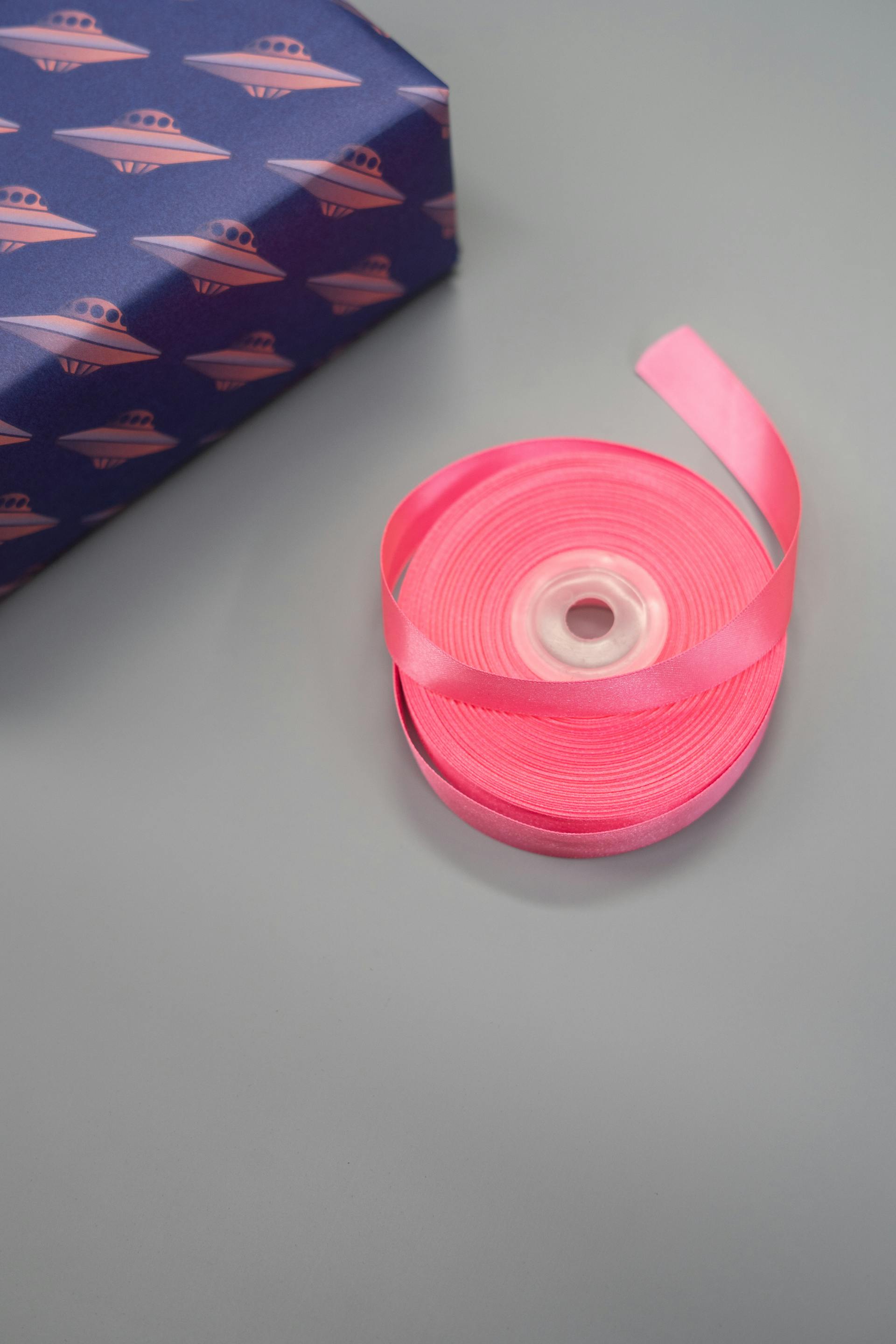 Pink ribbon lying beside a present | Source: Pexels