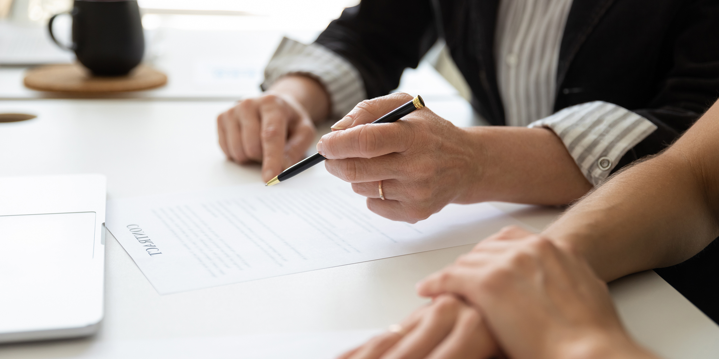 People sitting at a table with documents | Source: Shutterstock