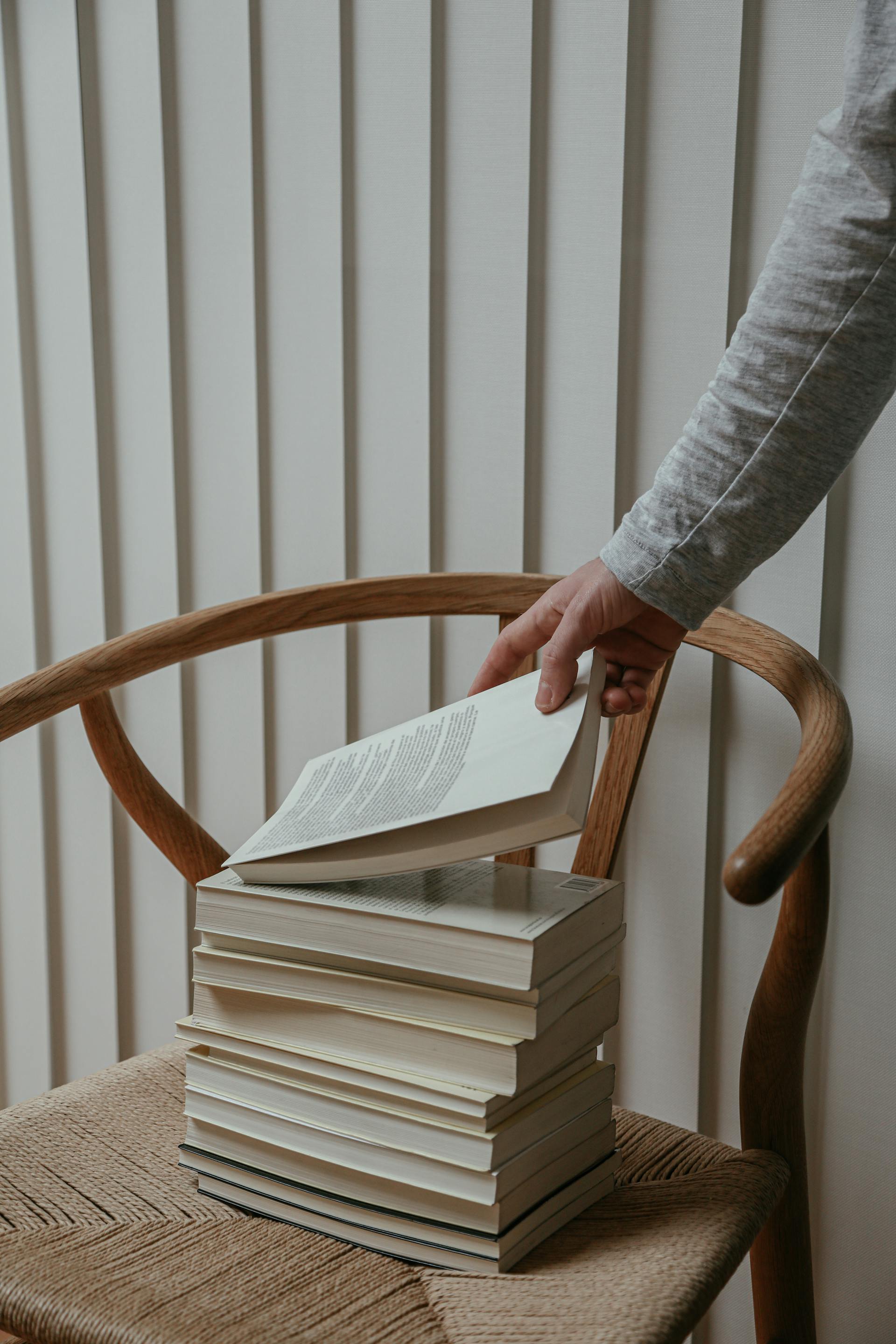 A person grabbing a book | Source: Pexels