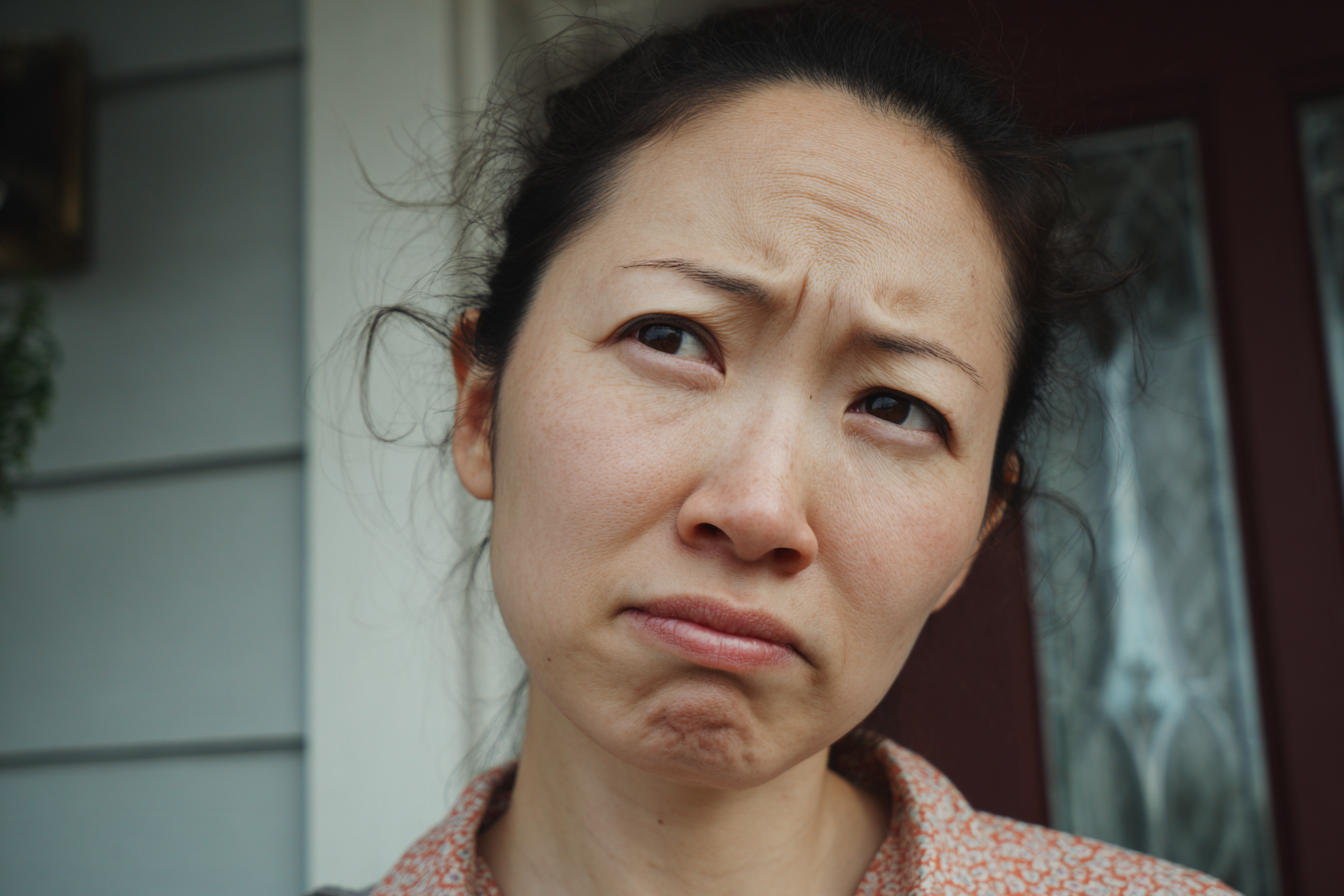 A woman frowning at someone | Source: Midjourney