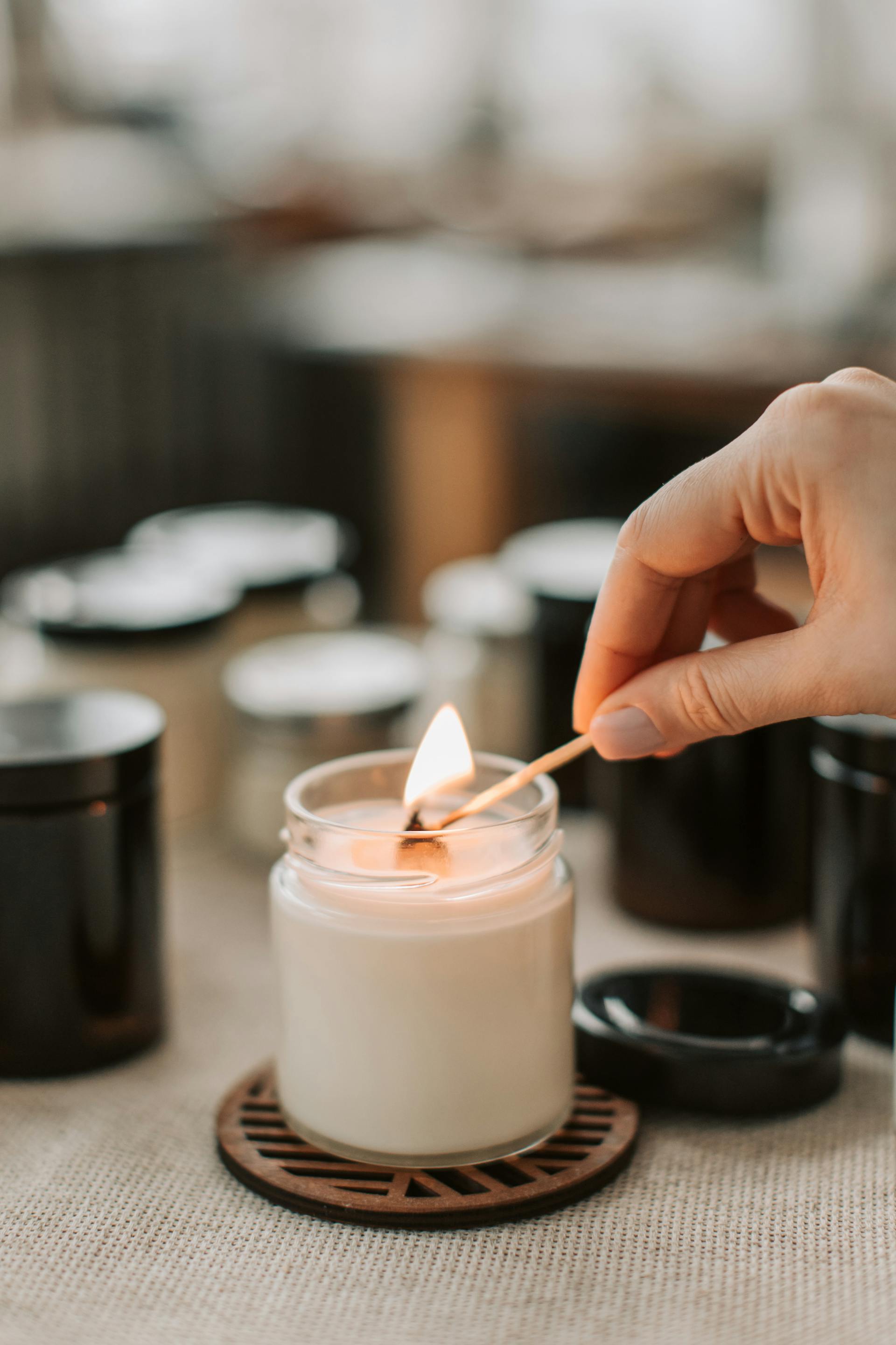 A close-up shot of a woman lighting a candle | Source: Pexels