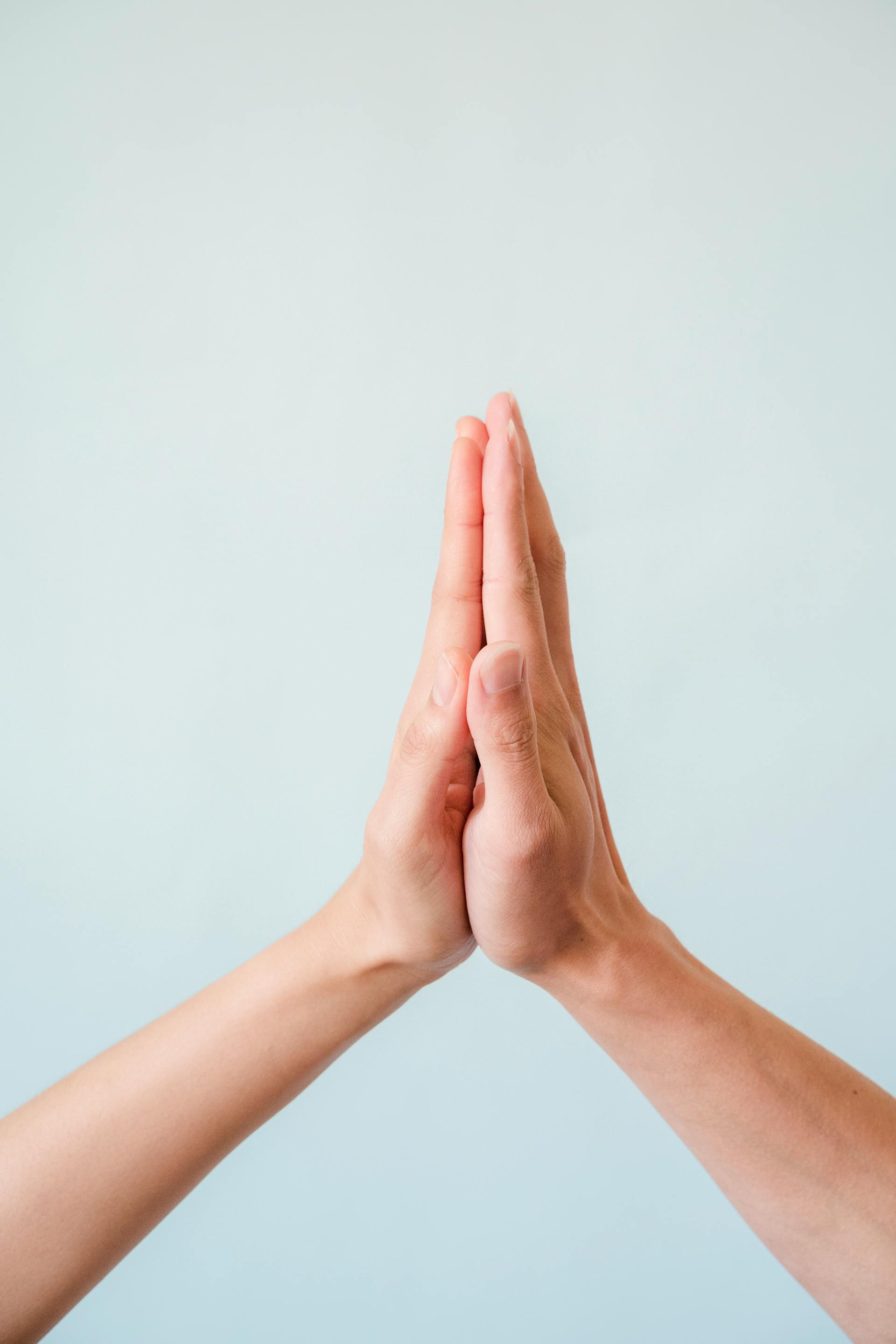 Two people giving each other a high-five | Source: Pexels