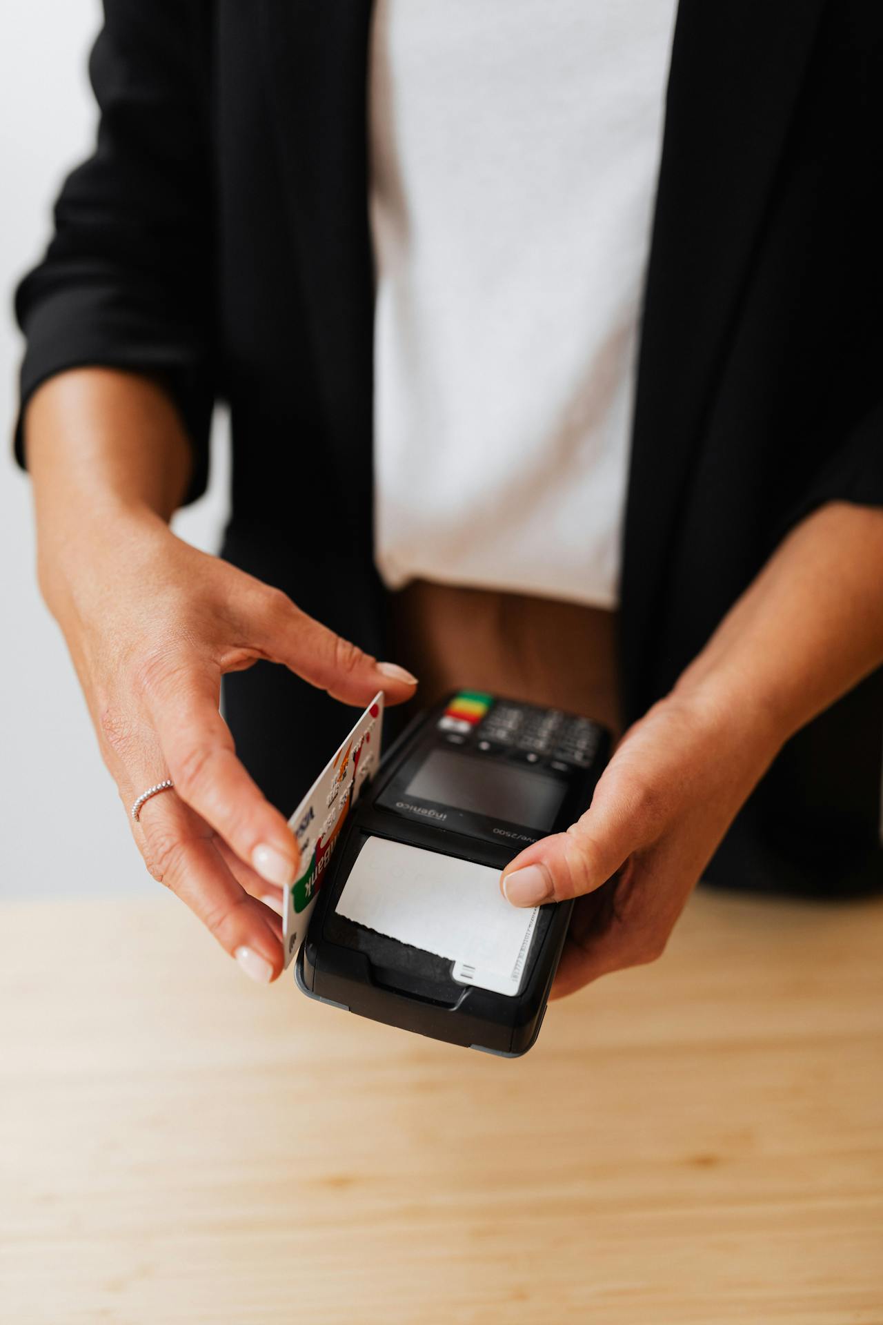 A woman swiping a card | Source: Pexels