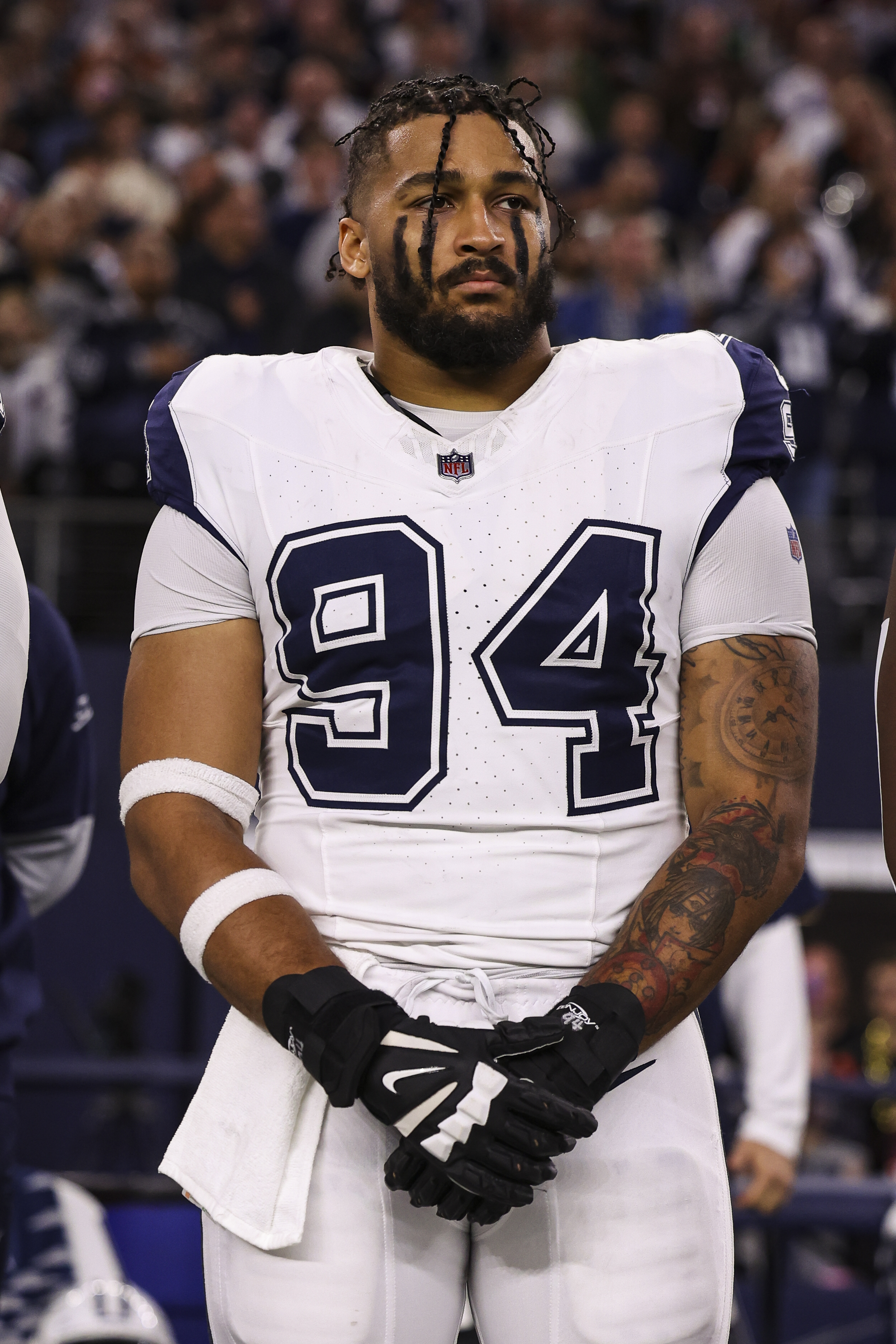 Marshawn Kneeland #94 of the Dallas Cowboys looks on from the sideline during the national anthem prior to an NFL football game against the Cincinnati Bengals at AT&T Stadium on December 9, 2024, in Arlington, Texas. | Source: Getty Images